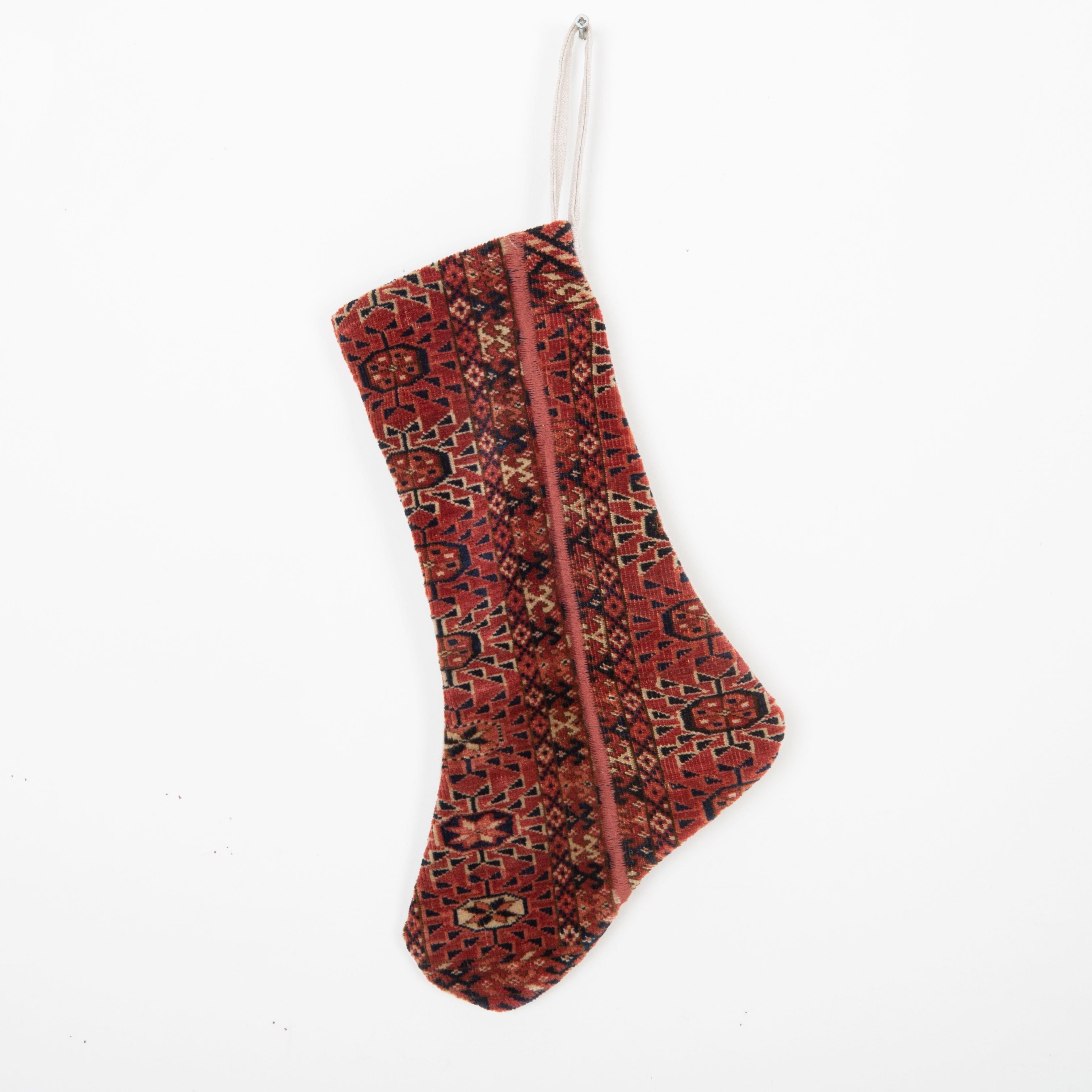 This Christmas Stocking was made from a late 19th or Early 20th C. Turkmen rug fragments.
Linen in the back.

Please note, this stocking was made from Turkmen rug fragments
