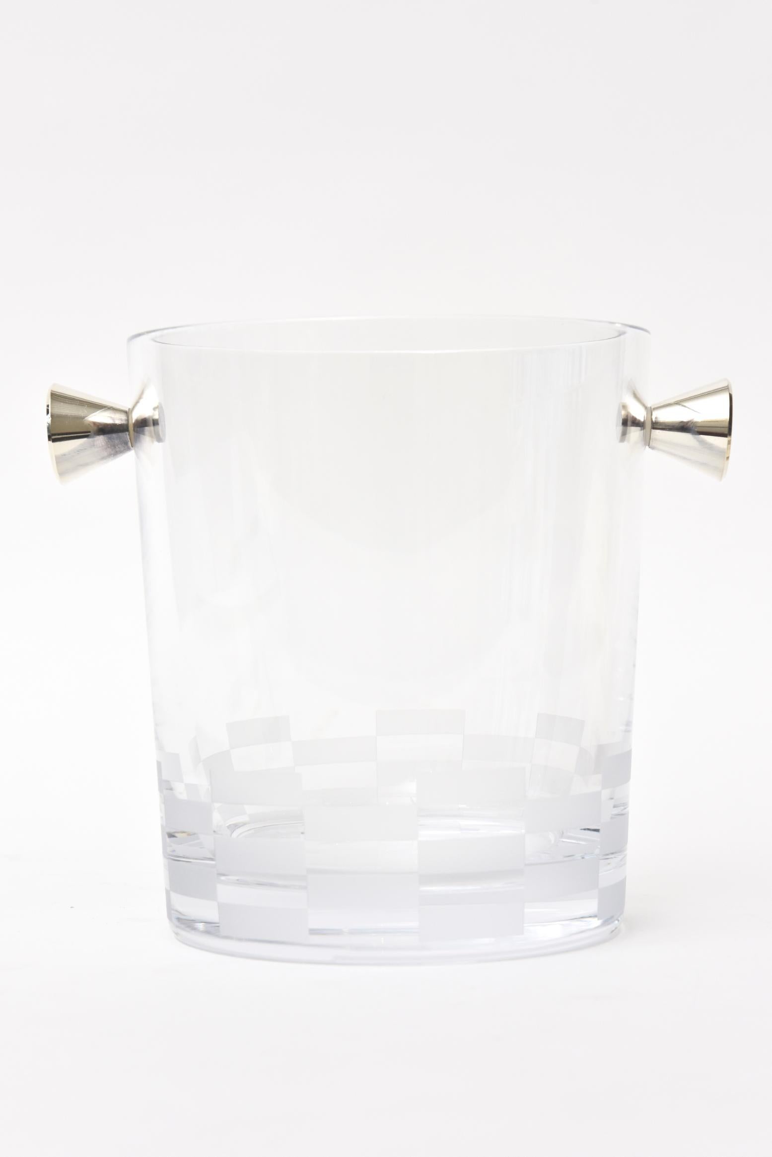 This lovely hallmarked French Christofle crystal ice bucket or champagne bucket is signed. it is from the 3000 collection. It has at the bottom 2 rows of checker board etched frosted glass and two sculptural silver plate handles on either side. It