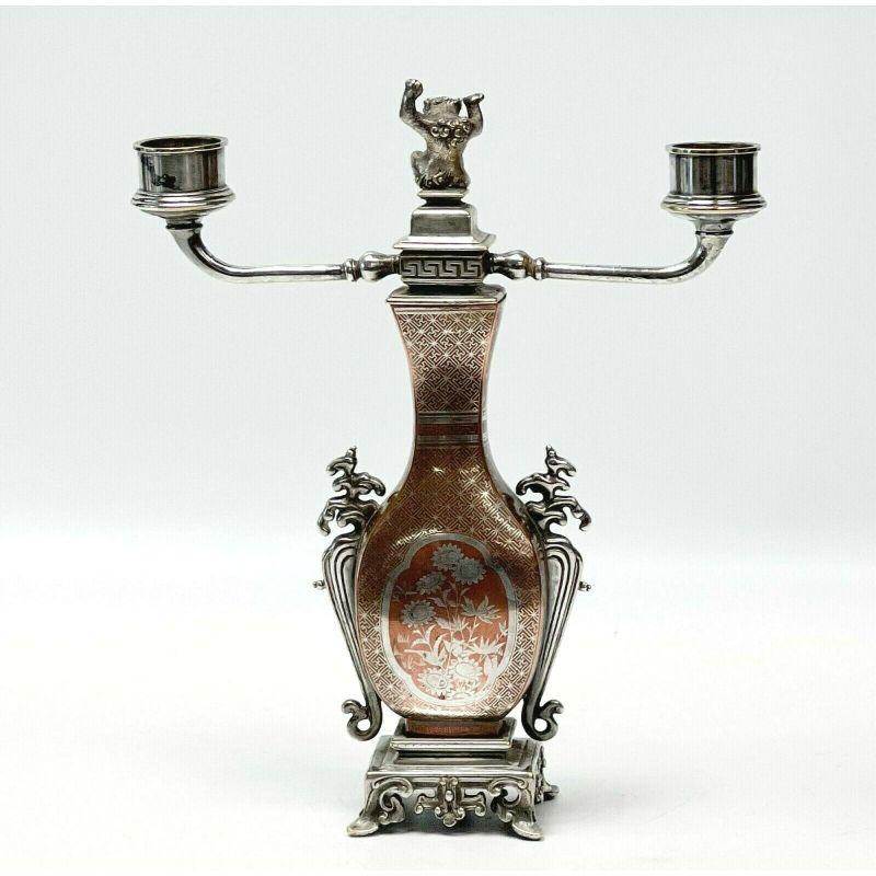 Christofle et Cie French Mixed Metal copper silver inlay gold plate candelabra

Christofle & Cie France candelabra, circa 1880. Copper body with inlaid silver floral decoration, silver plate and gold plated highlights to the base, branches, and