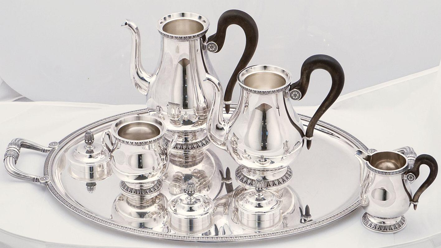 A handsome tea and coffee set of fine plate silver by the celebrated French silver company, Christofle.

Includes large oval serving tray with raised decorative edge and opposing handles, tea pot with removable fitted lid and ebonized wood handle,