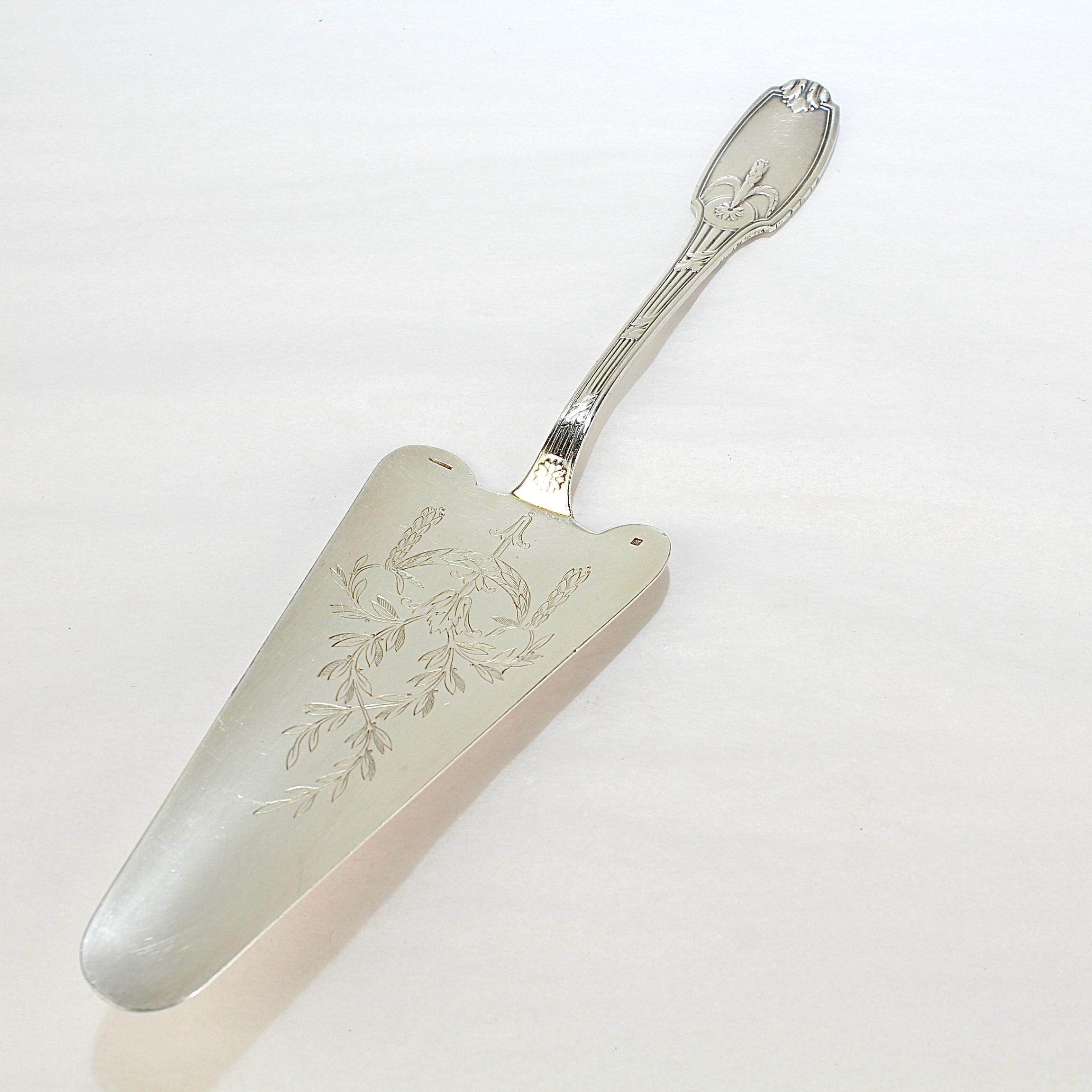 A fine silver plate cake or pie server.

By Christofle France.

In the Delafosse pattern with wheat & flower decoration throughout. 

Simply a wonderful server in the hard-to-find Delafosse pattern!

Date:
Early 20th Century

Overall Condition:
It