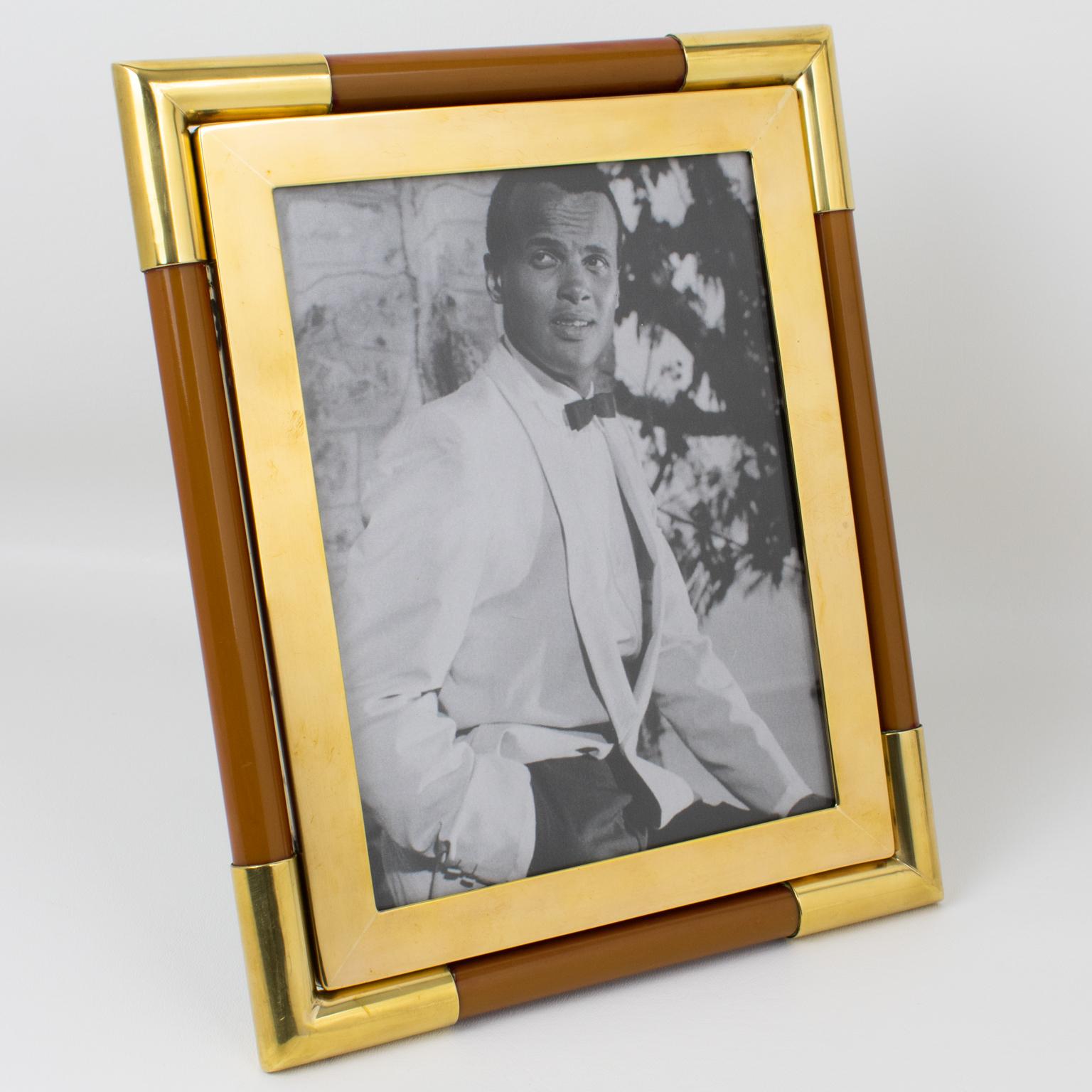 Silversmith Christofle, Paris, crafted this luxury brass and resin picture frame for its Christofle Collection in the 1970s. The elegant and sophisticated design boasts solid polished brass framing complimented with toffee brown resin tube elements.