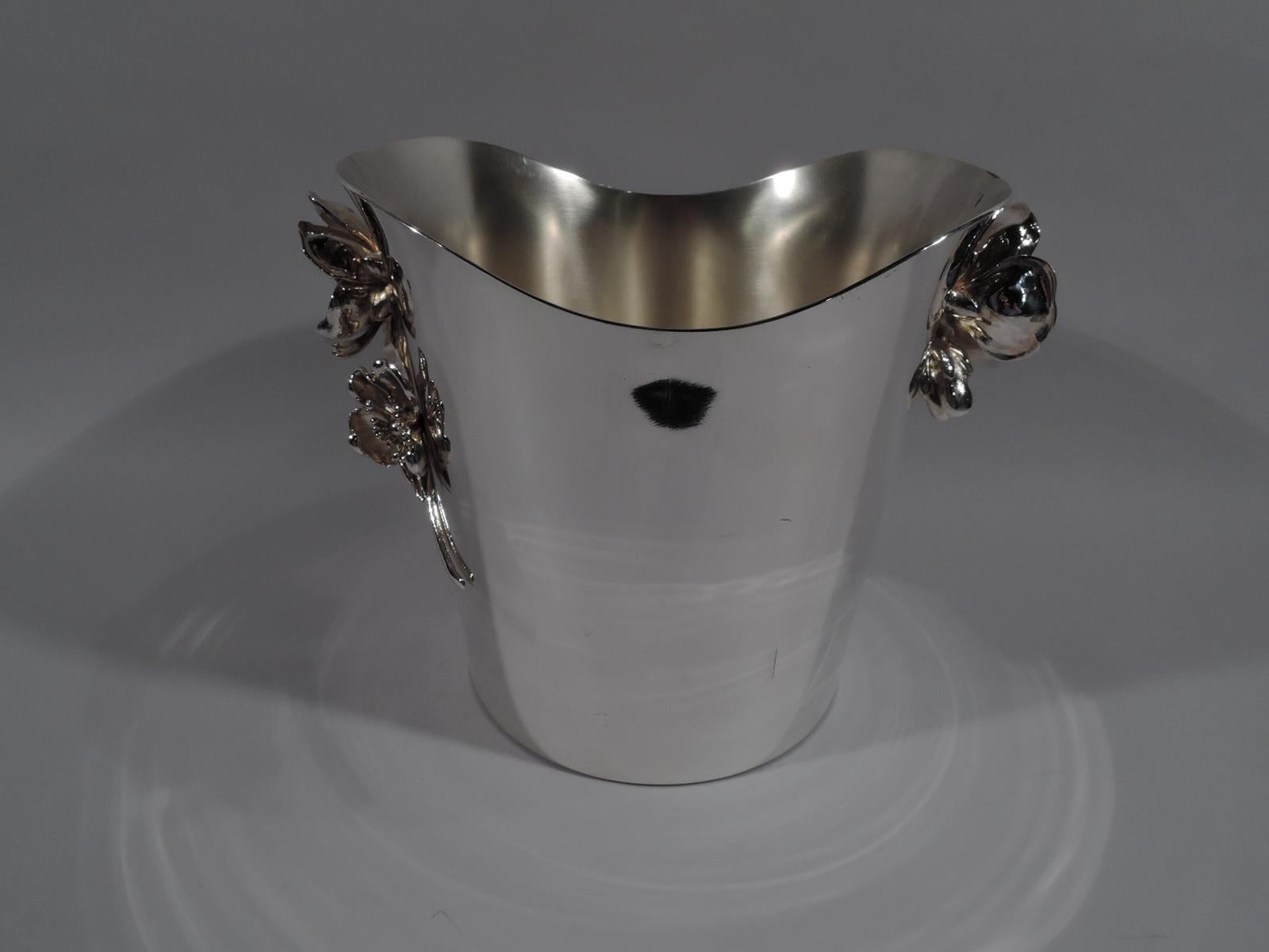 Art Nouveau silver plate champagne bucket. Made by Christofle in France. Oval mouth with straight and tapering sides and swooping asymmetrical mouth. Applied side handles in form of two flower heads on one scrolled stem. On front in low relief is