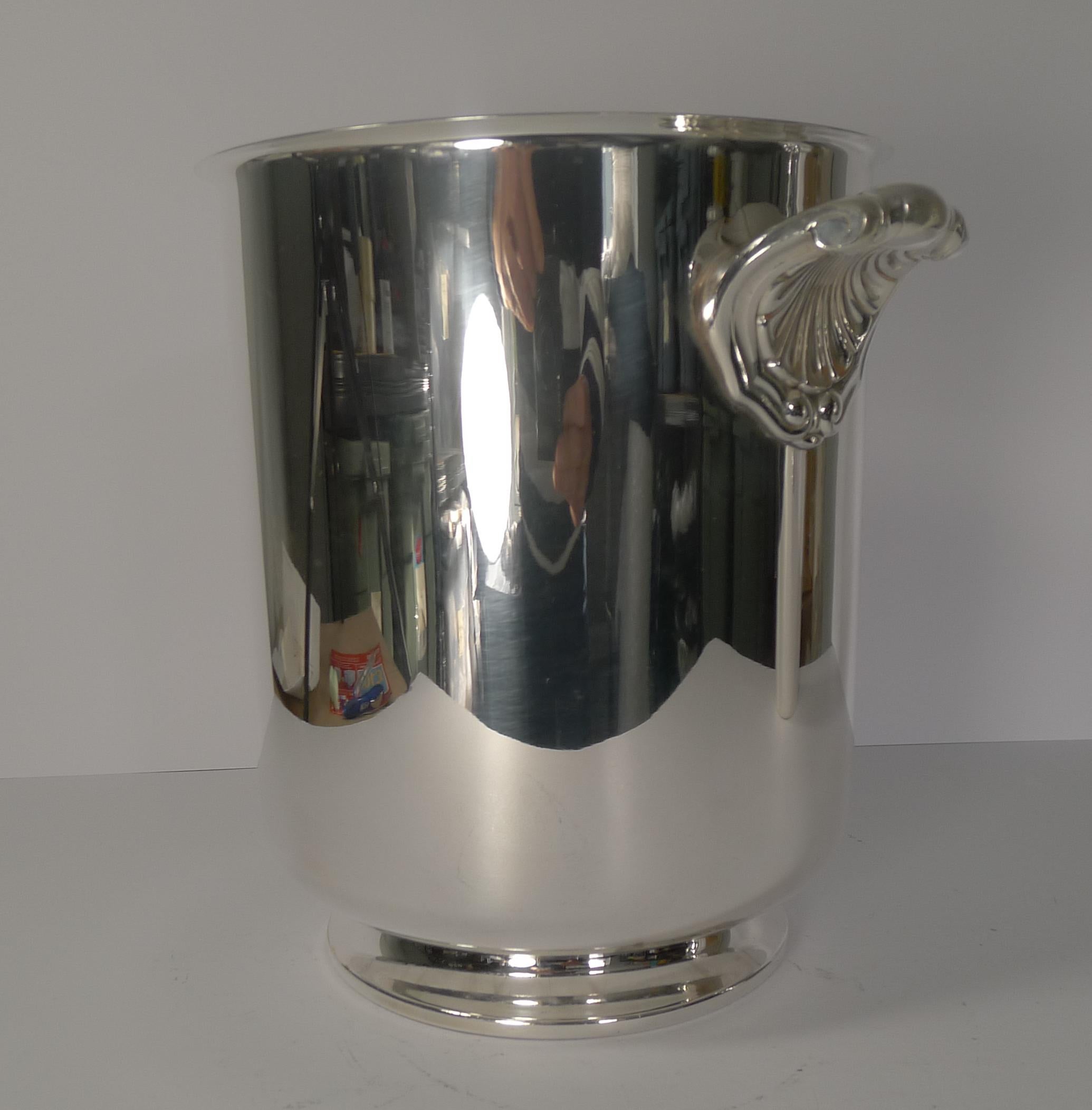 A stunning vintage champagne bucket in silver plate, a hefty quality piece by the famous French Orfevrerie Christofle of Paris.

This design is called Ormesson with it's simple lines and footed base and two fabulous shell handles; a lovely post