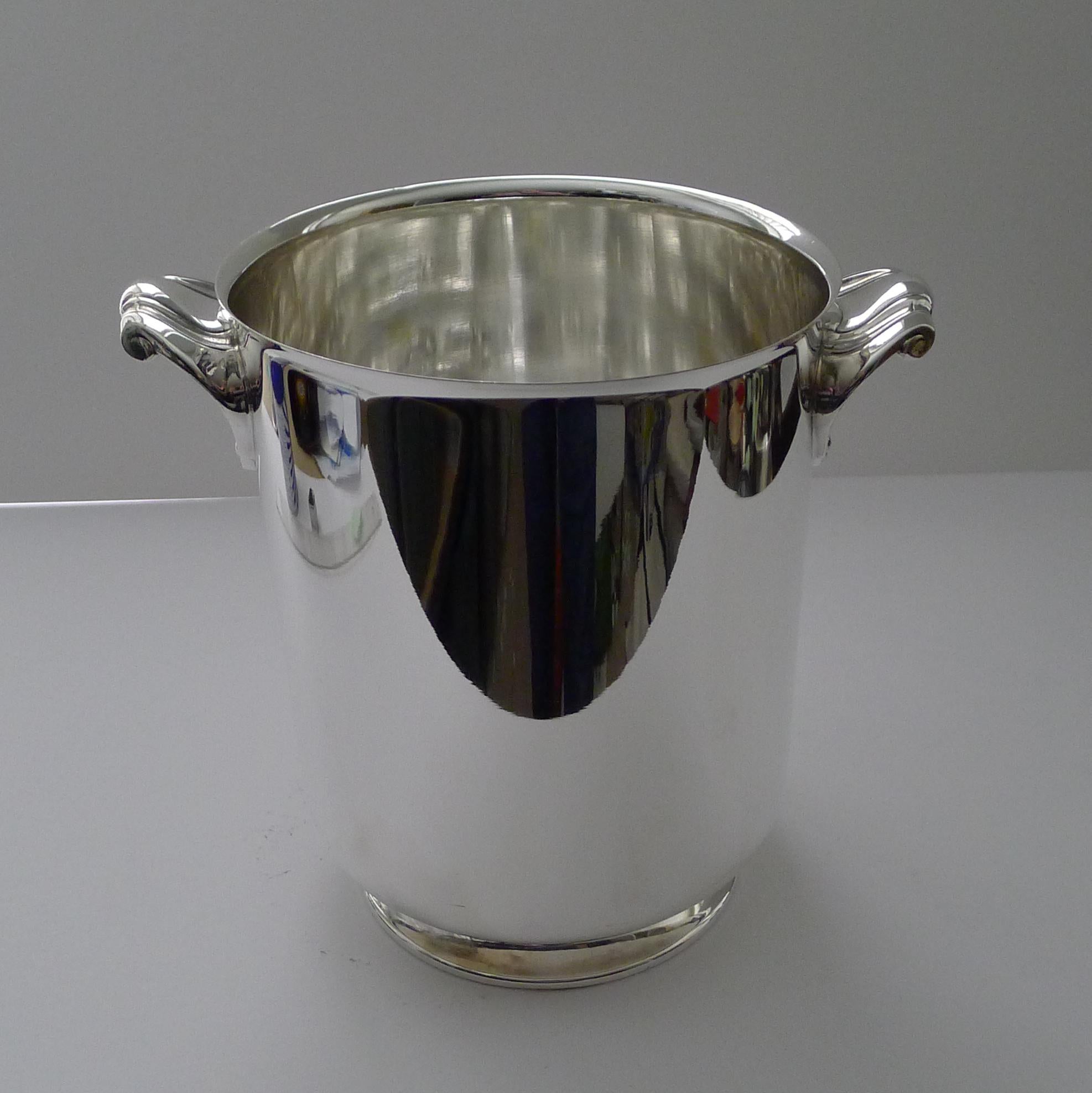 A stunning vintage champagne bucket in silver plate, a hefty quality piece by the famous French Orfevrerie Christofle of Paris.

This design is called Ormesson with it's simple lines and footed base and two fabulous shell handles a lovely post Art