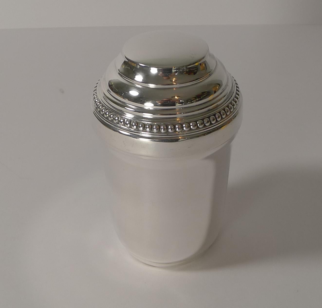 A charming and unusual individual cocktail shaker with an integral lemon squeezer / reamer by the top notch French silversmith, Maison Christofle.

The silver plated shaker is part of the Gallia range and dates to circa 1930-1940, fully marked on