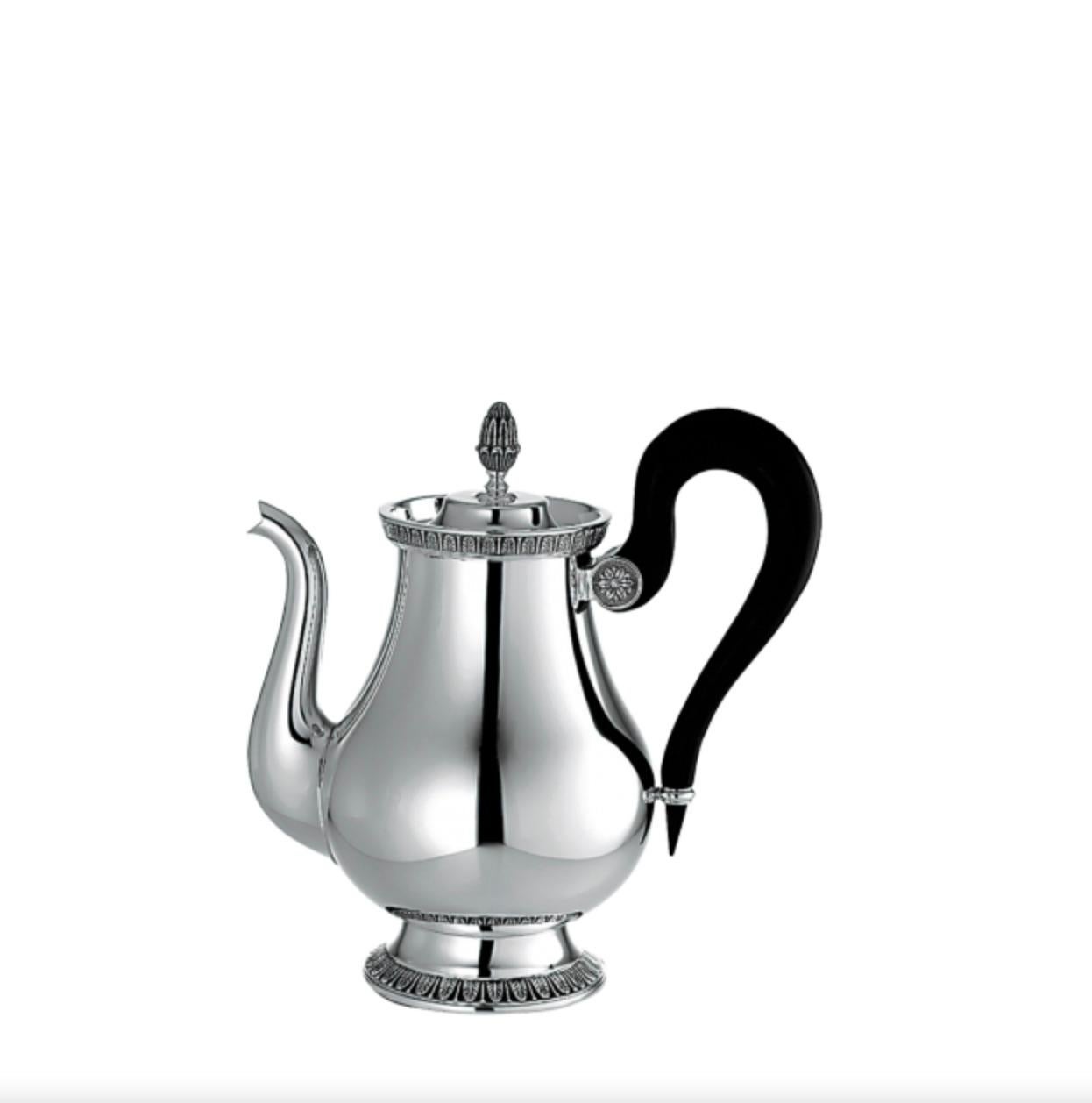 Set elegant table with teapot in the Christofle Malmaison pattern. One of Christofle's most historic patterns, Malmaison typifies the Empire style, with its frieze of delicate palm and lotus leaves and symmetrical design. The name is a nod to the