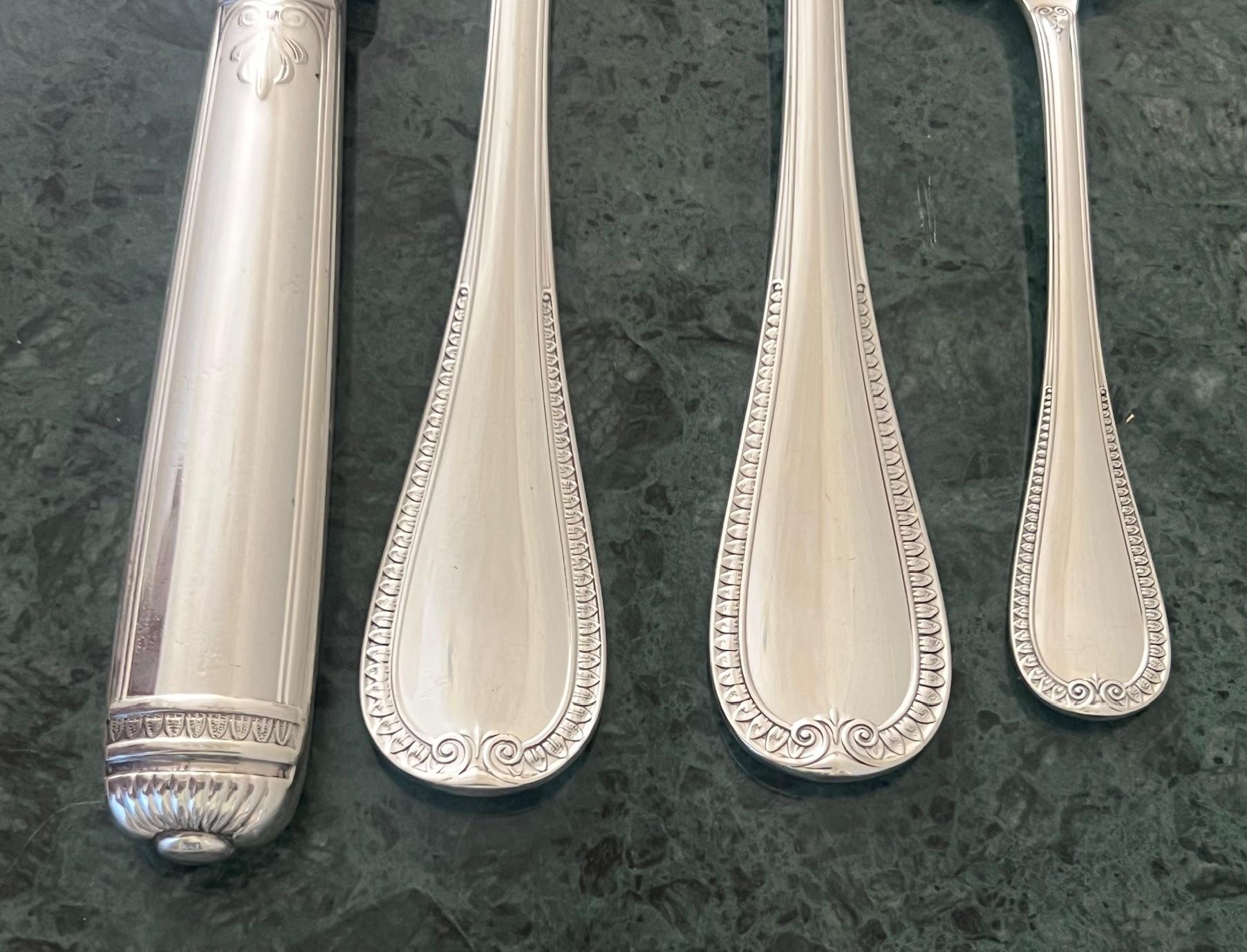 Service de couverts de quarante-neuf pièces fabriqué par Christofle en France, dans le motif Malmaison. Le service pour douze a été mis en place vers 2000. Toutes les pièces sont poinçonnées et sont livrées dans une boîte neuve avec de la place pour