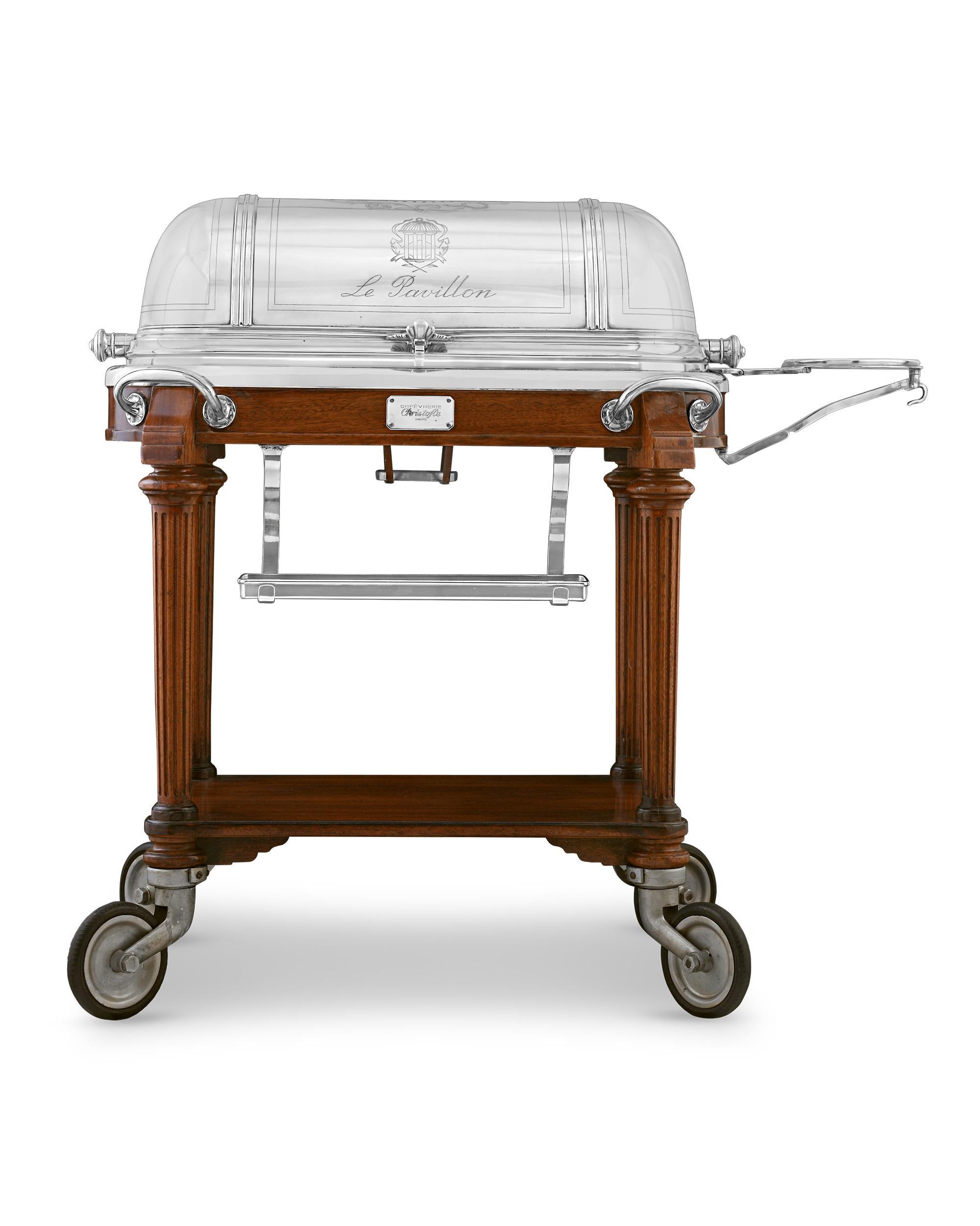 This extraordinary silverplate meat carving trolley was crafted in the 1940s by the prestigious firm Christofle & Cie for New York City’s premier restaurant of the day, Le Pavillon. The top of the shiny domed lid is emblazoned with the restaurant's