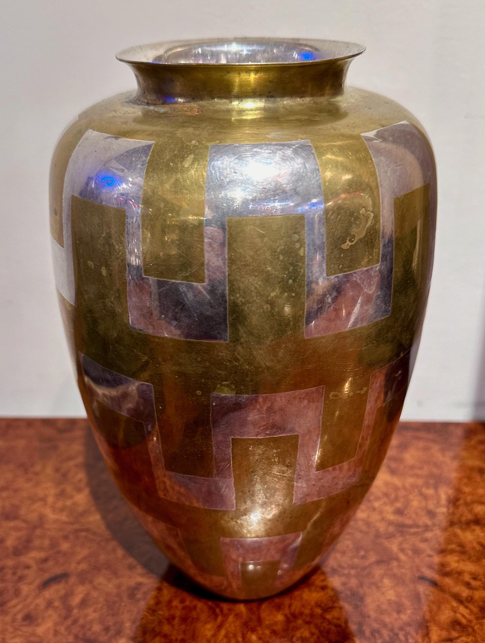 The Christofle Metal Vase, designed by Luc Lanel circa 1925, is a notable piece of Art Deco design. Luc Lanel was a French designer closely associated with the Art Deco movement. He worked for the prestigious French luxury company Christofle, known
