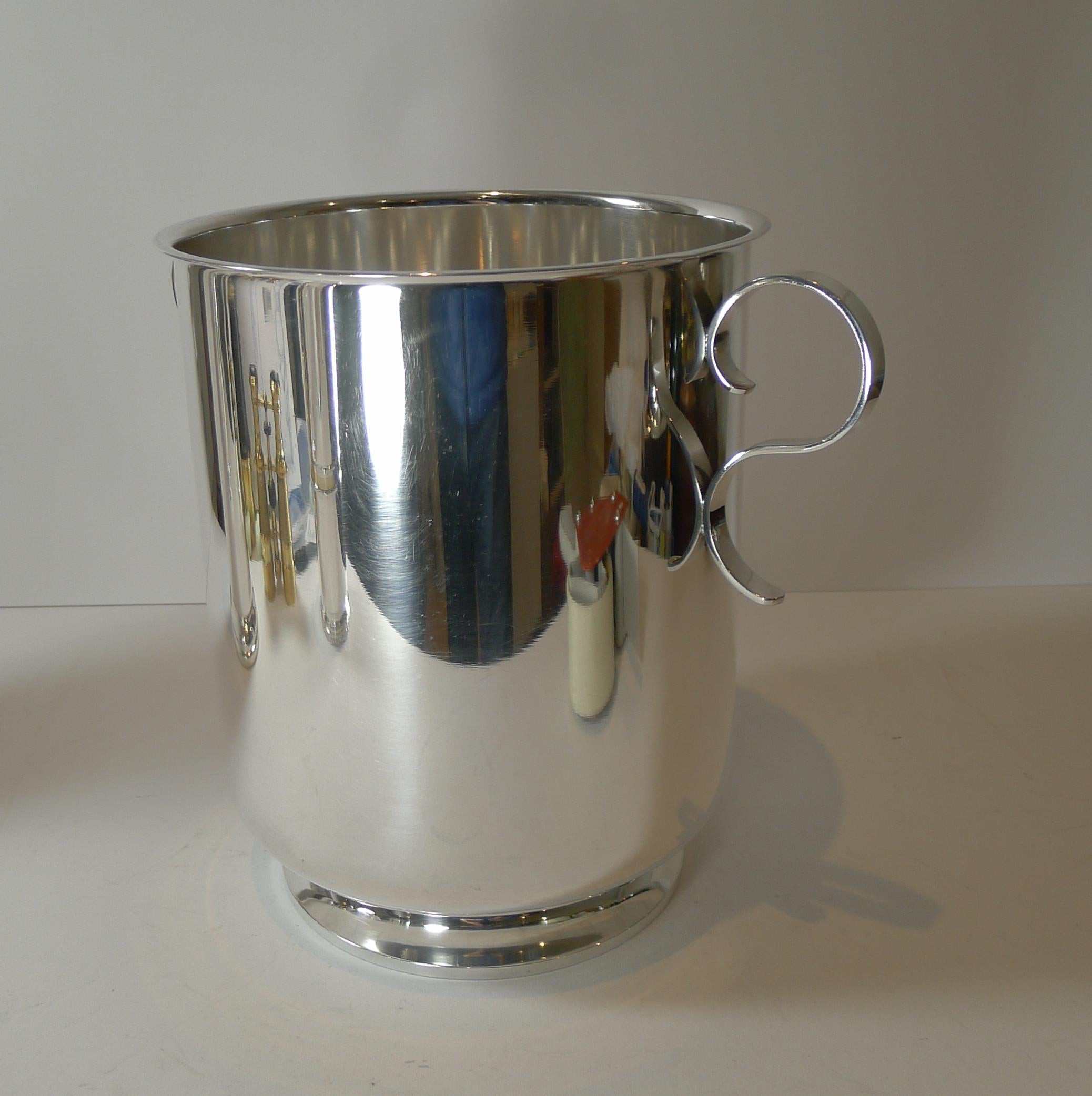 A rarely found model with it's footed base and two very elegant scroll handles, this silver plated champagne bucket was made by the top-notch Parisian silver and goldsmith's, Orfèvrerie Christofle as part of their highly collectable Gallia