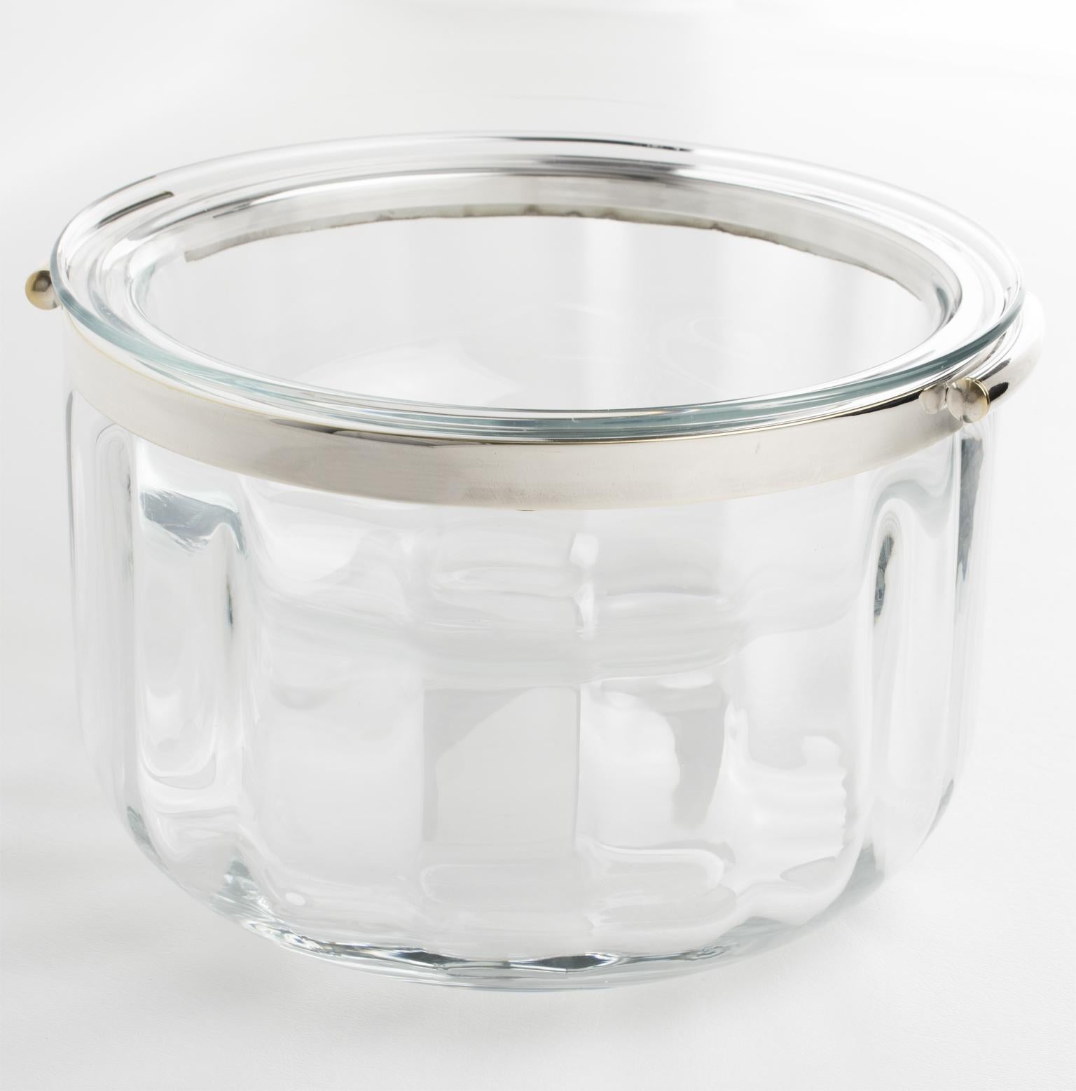 This stylish French modernist silver plate and crystal caviar serving bowl, dish, or chiller was designed by silversmith Christofle in the 1950s for its Fleuron Collection. 
This set features a two-handled, rounded outer crystal ice bowl container