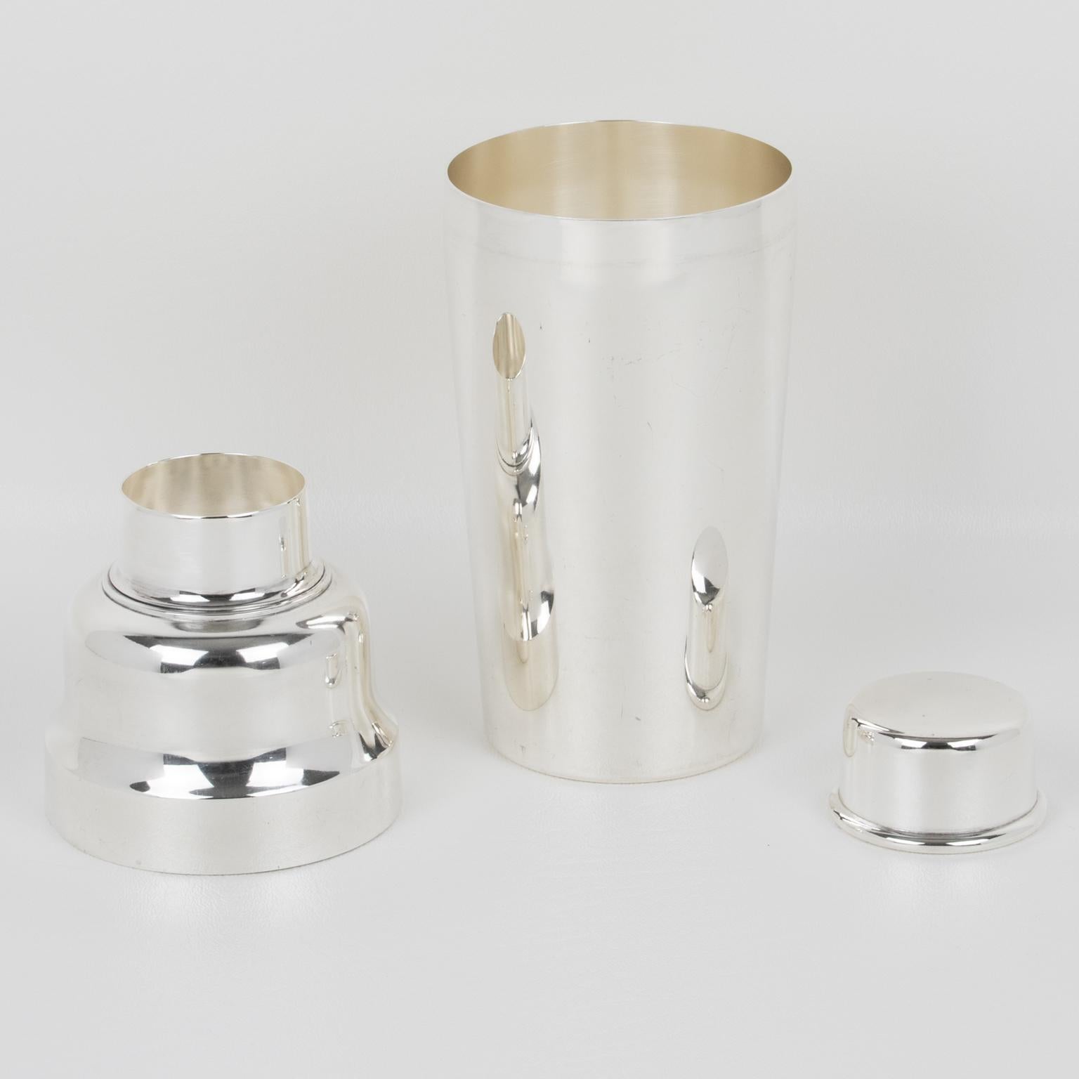 An elegant French Mid-Century, 1950s silver plate cylindrical cocktail or Martini shaker designed by silversmith Christofle, Paris. The three-sectioned designed cocktail shaker has a removable cap and strainer. The lovely streamlined modernist