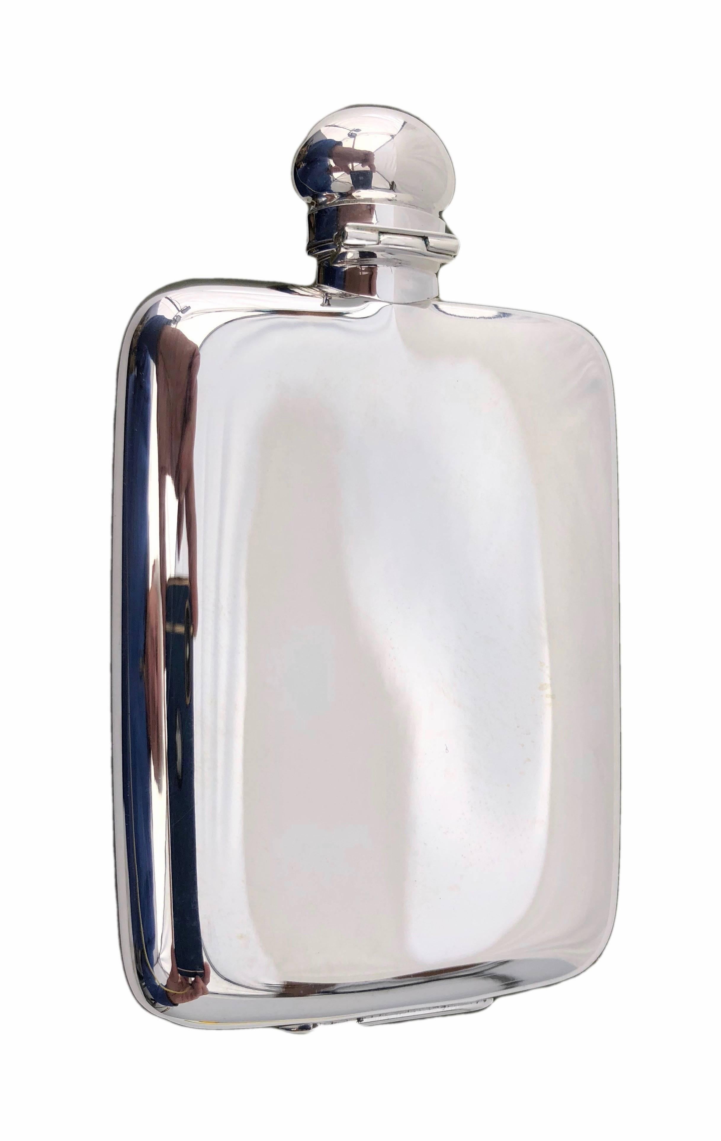 This beautiful Christofle plated silver whisky flask is the model Aria made in the late 1900s. It has a beautiful front band design and a silver plated hinged button top. It has never been used and comes in its original box with identifying label. A