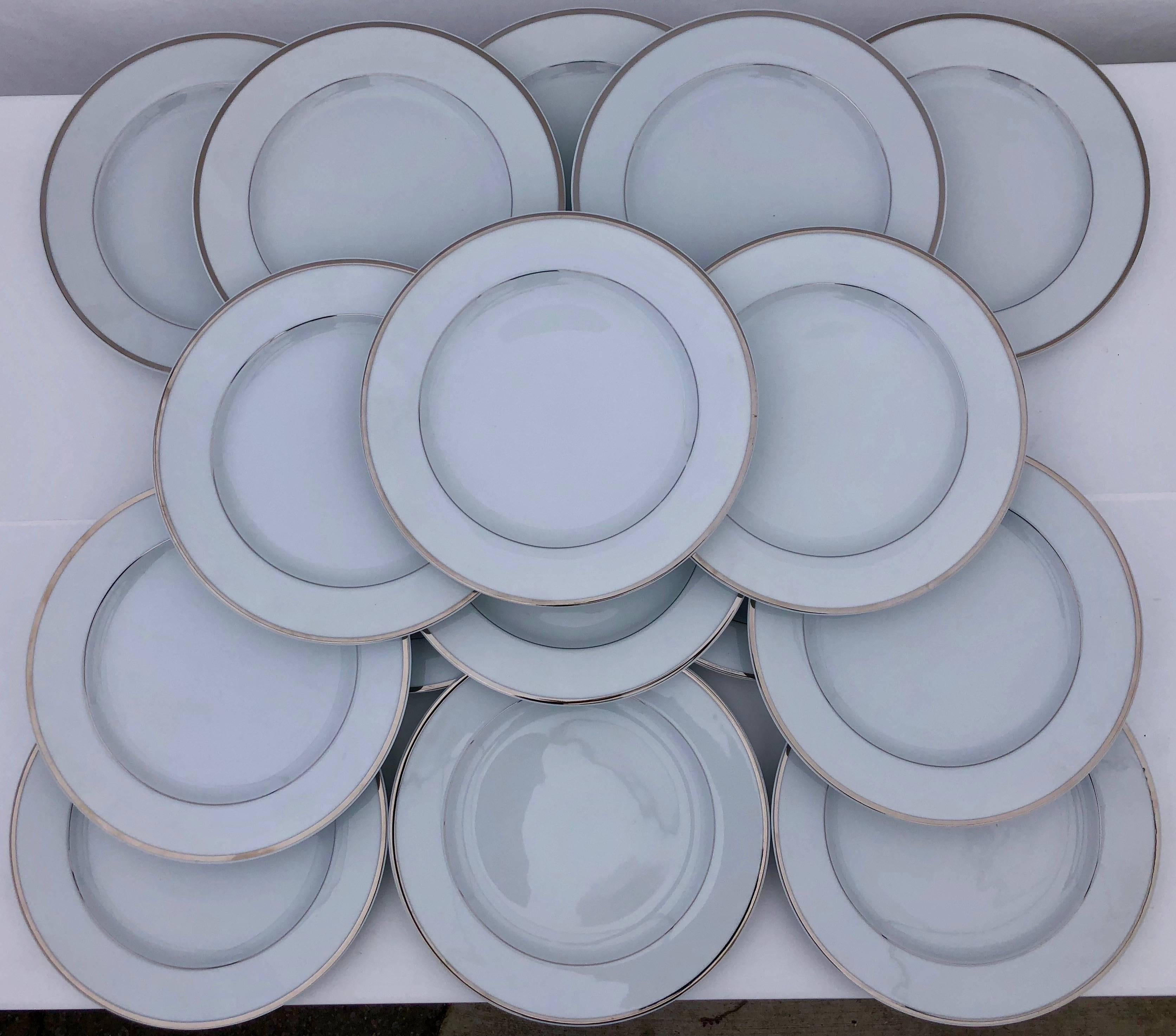 These elegant large Christofle white porcelain plates have two decorative silver bands and, although nearly 40 years old, are in excellent condition. The plates were purchased in 1980 by a two Michelin Star restaurant in Paris, but forgotten in