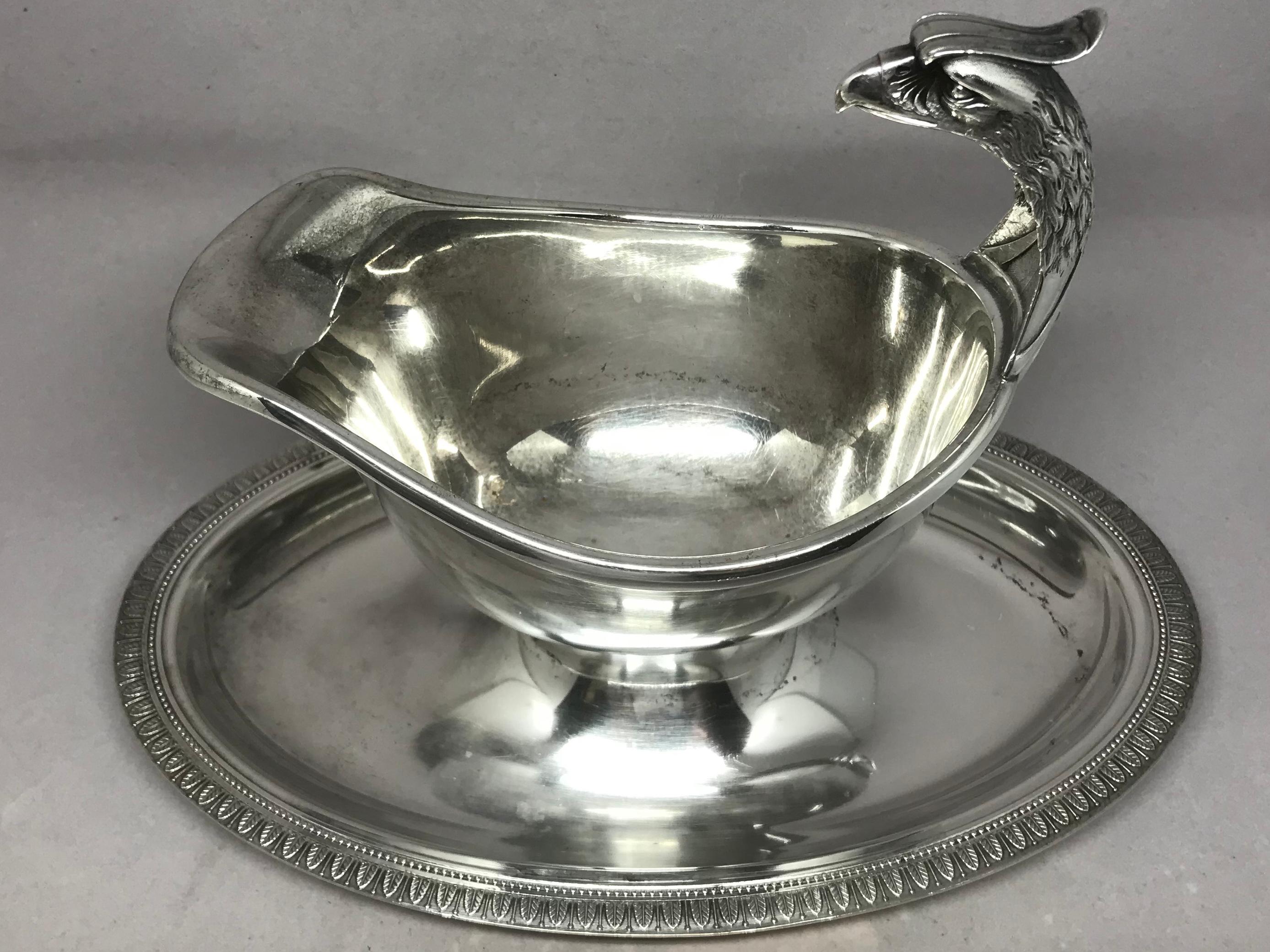 Christofle silver eagle gravy boat. Handsome eagle headed hotel silver gravy/sauce boat with attached underplate with hallmarks for Christofle, France, 20th century.
Dimensions: 9.25