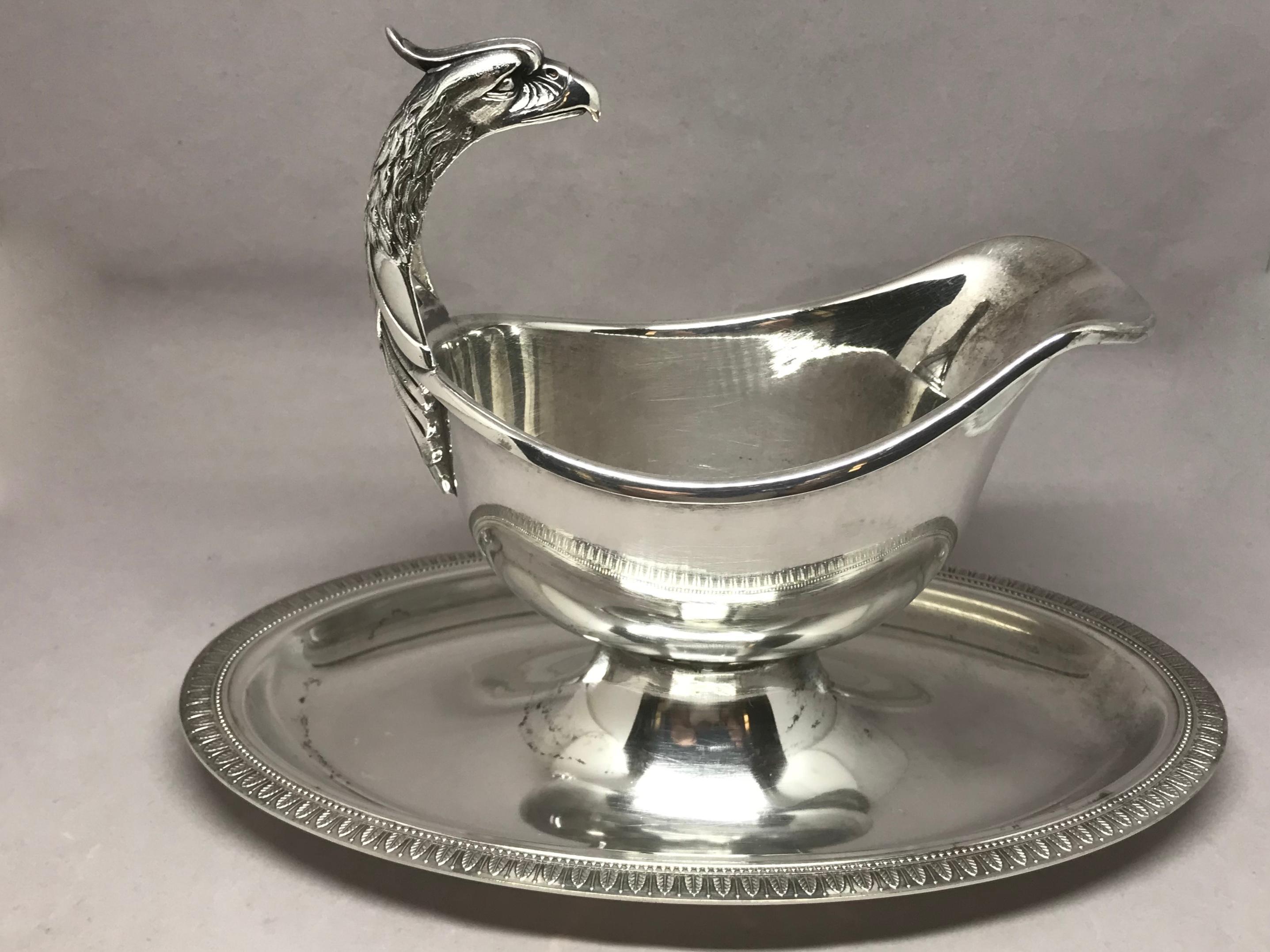 silver gravy boat with attached plate