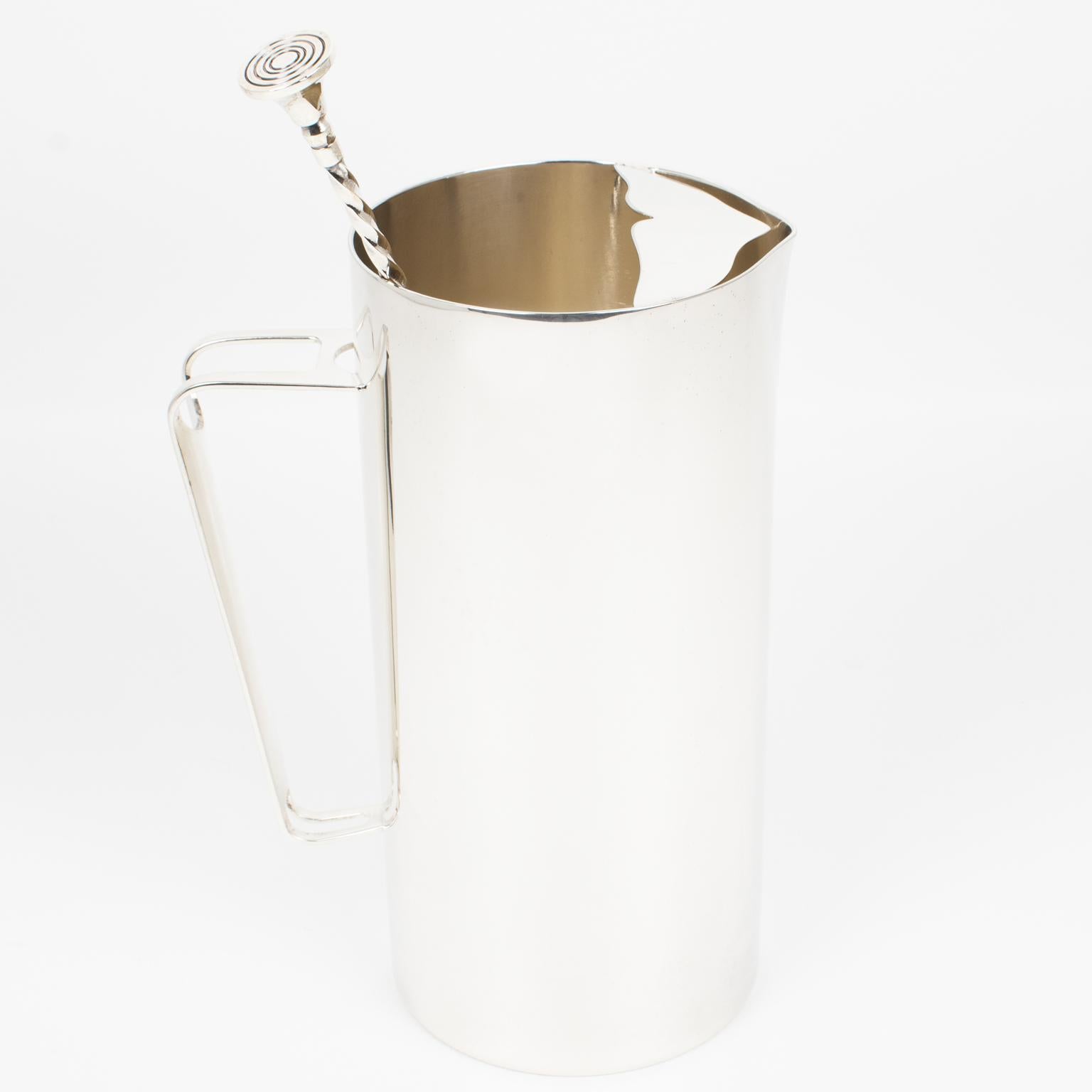 Christofle, Paris, designed this sophisticated barware set in the 1960s. The silver plate martini pitcher or mixer jug has a sleek and modernist shape and comes with a long stirrer spoon. The long spoon is marked with the company's legal silversmith