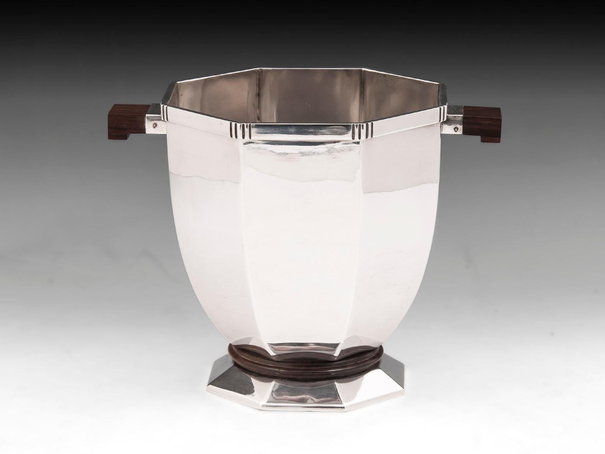 Rare French Art Deco silver plated champagne bucket by Christofle with maccassar ebony handles and turned plinth.

 
