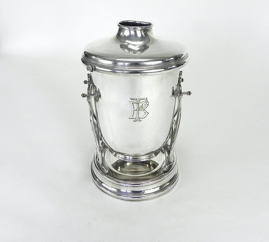 This rare Christofle silver plated champagne pourer is in very good condition. No missing parts and the majority of the silver is still bright and shiny.

The lidded ice bucket that sits in a decorative caddy tilts as intended in order to pour
