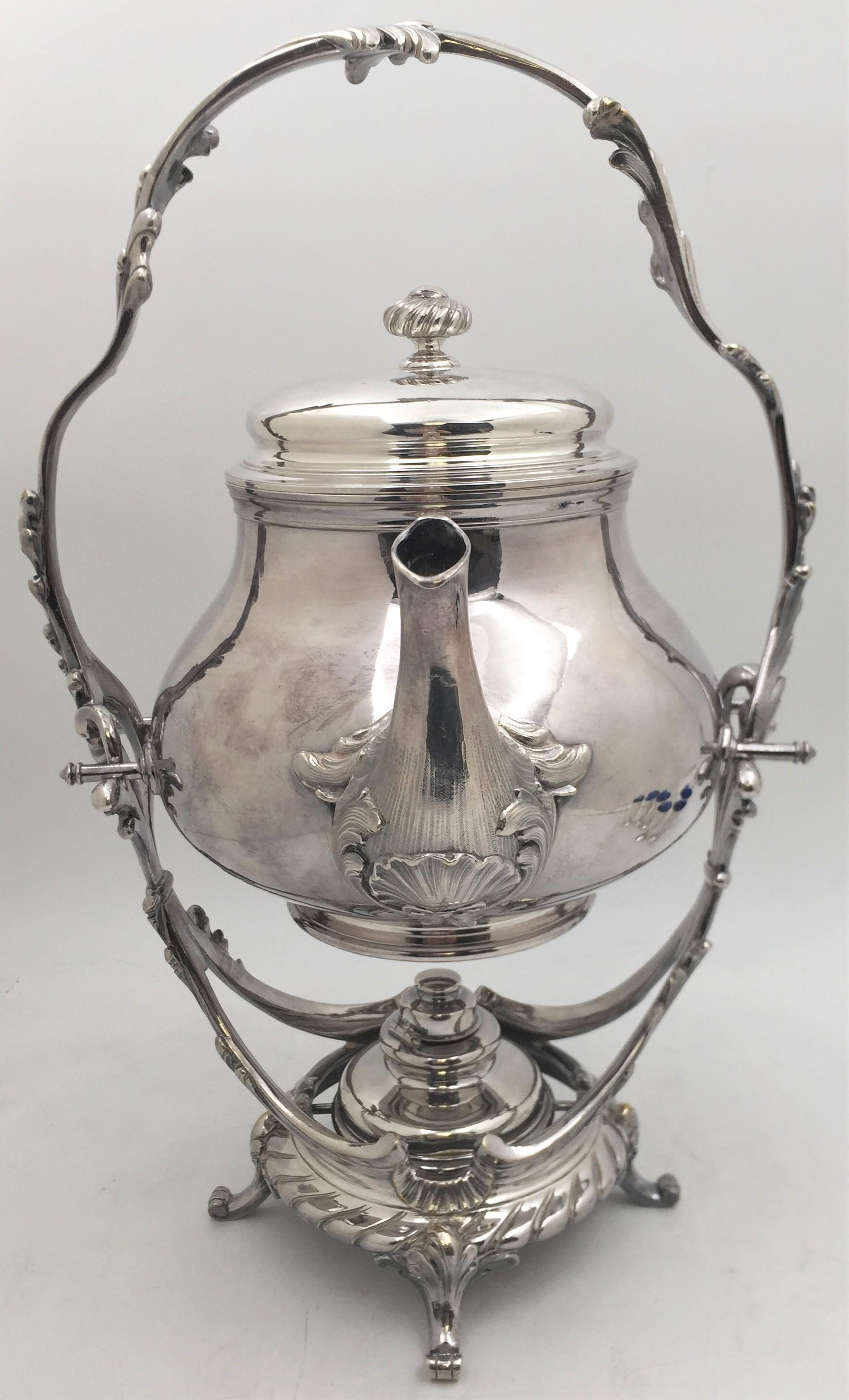 Christofle silver plated kettle on stand in ornate Rococo style with swirling natural motifs. The stand, which has 4 legged feet, measures an impressive 16 1/2'' in height by 7 1/4'' in depth. The kettle measures 8 1/2'' in height by 7 1/2'' in