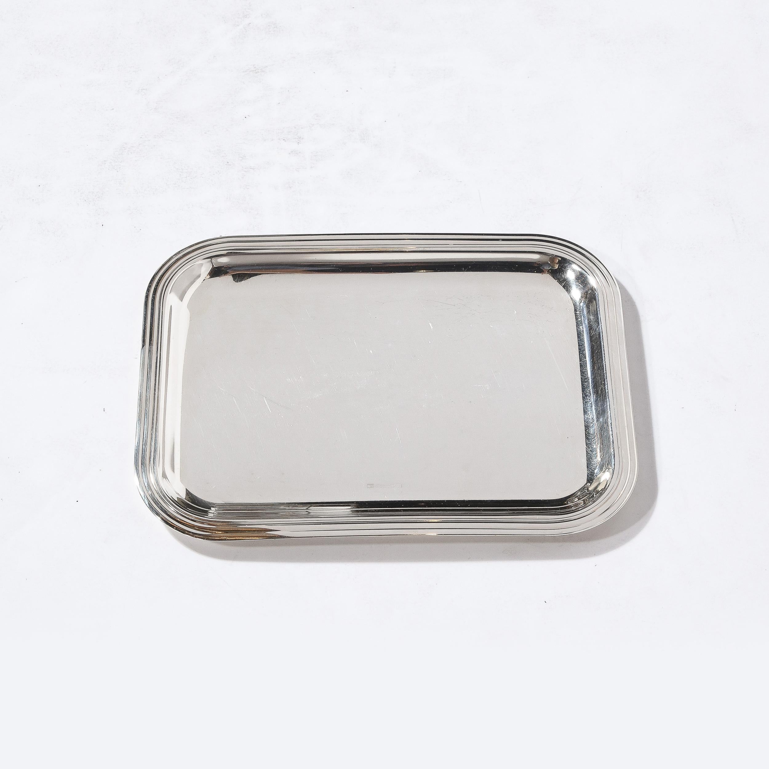 This sleek Christofle Silver-Plated Art Deco Style Tray originates from France, Circa 2000. Featuring gorgeous grooved detailing circumscribing the edge of the tray, this piece is beautifully proportioned and is perfect for display and frequent use.