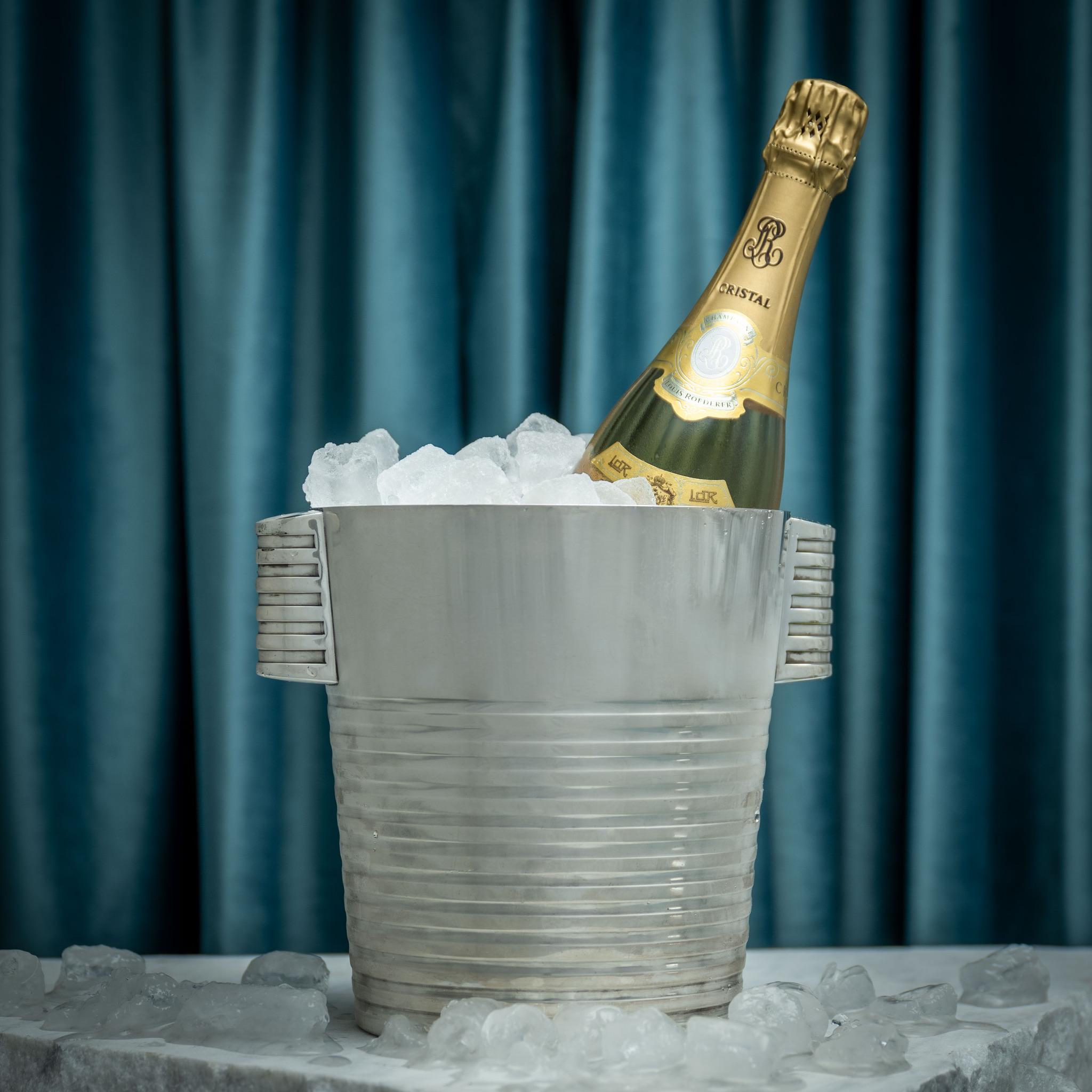 A wonderful silver plated ice bucket designed in 1933 by Luc Lanel for the famed Parisian silversmith, Christofle. This model, with ridge design to the handles and body, was to a pattern called “Ondulations”, and was originally designed for the