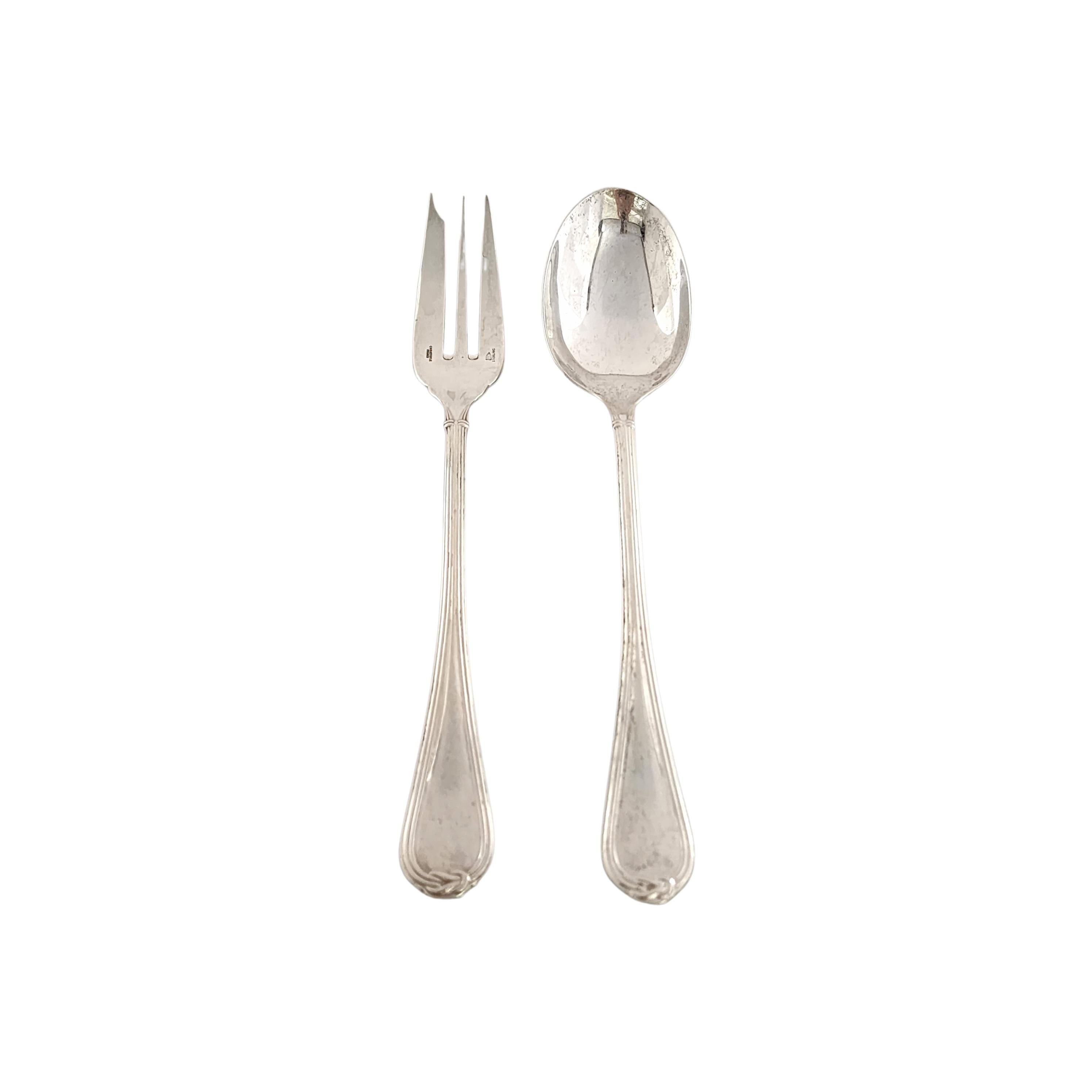 Sterling silver salad serving fork and spoon set in the Oceana pattern by Christofle.

A beautiful large serving set in a simple and elegant pattern, including a spoon and fork.

Spoon measures approx 10