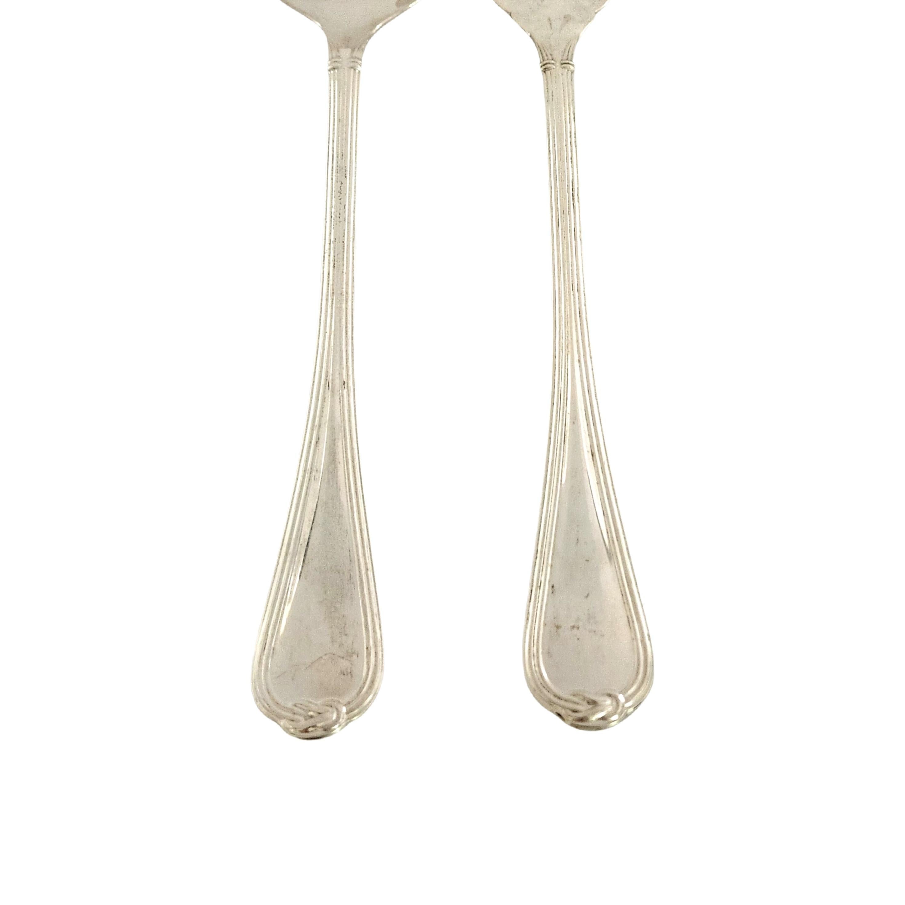 Sterling silver salad serving fork and spoon set in the Oceana pattern by Christofle.

A beautiful large serving set in a simple and elegant pattern, including a spoon and fork.

Spoon measures approx 10