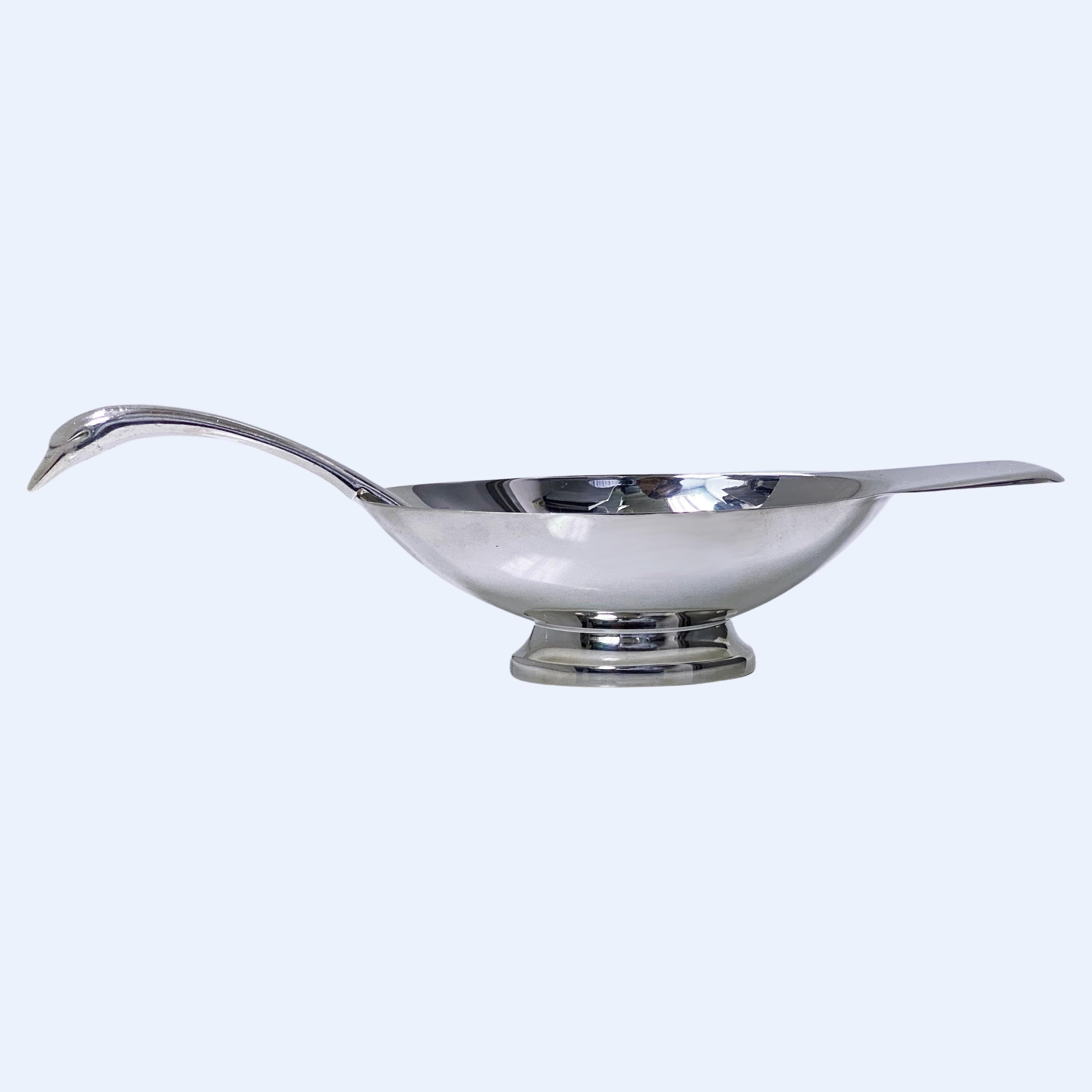 Christofle Swan Sauceboat C.1935 designer Christian Fjerdingstad. Silver Plate Sauceboat and Ladle conforming to the shape of a swan, designed by Christian Fjerdingstad for Christofle, France. C. 1935. The Sauceboat on oval shaped base, plain oval