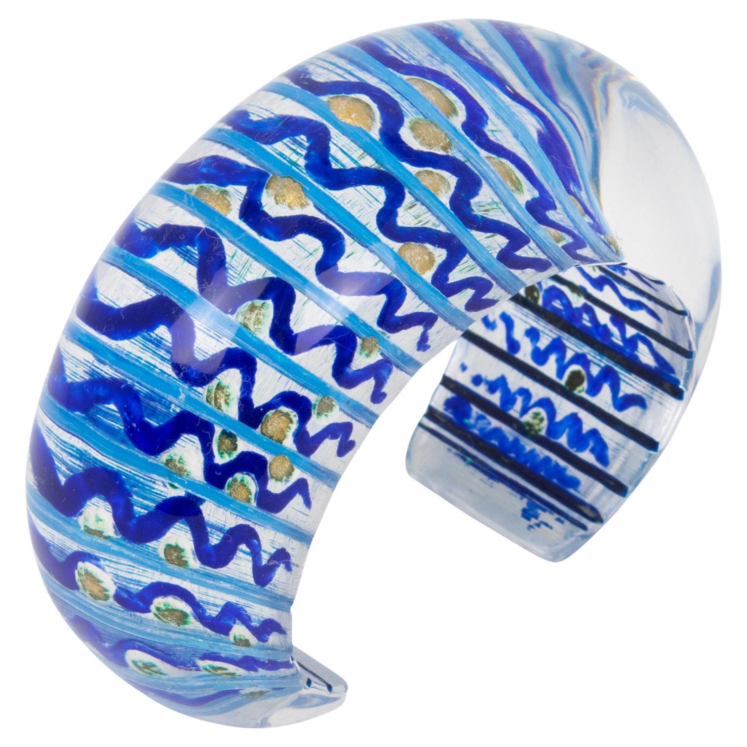 This spectacular Christophe Gallard Lucite cuff bracelet is an incredible piece. This French artist is famous for his sculptures, but his jewelry is equally impressive. The piece features a bold transparent Lucite or Altuglas cuff shape embellished