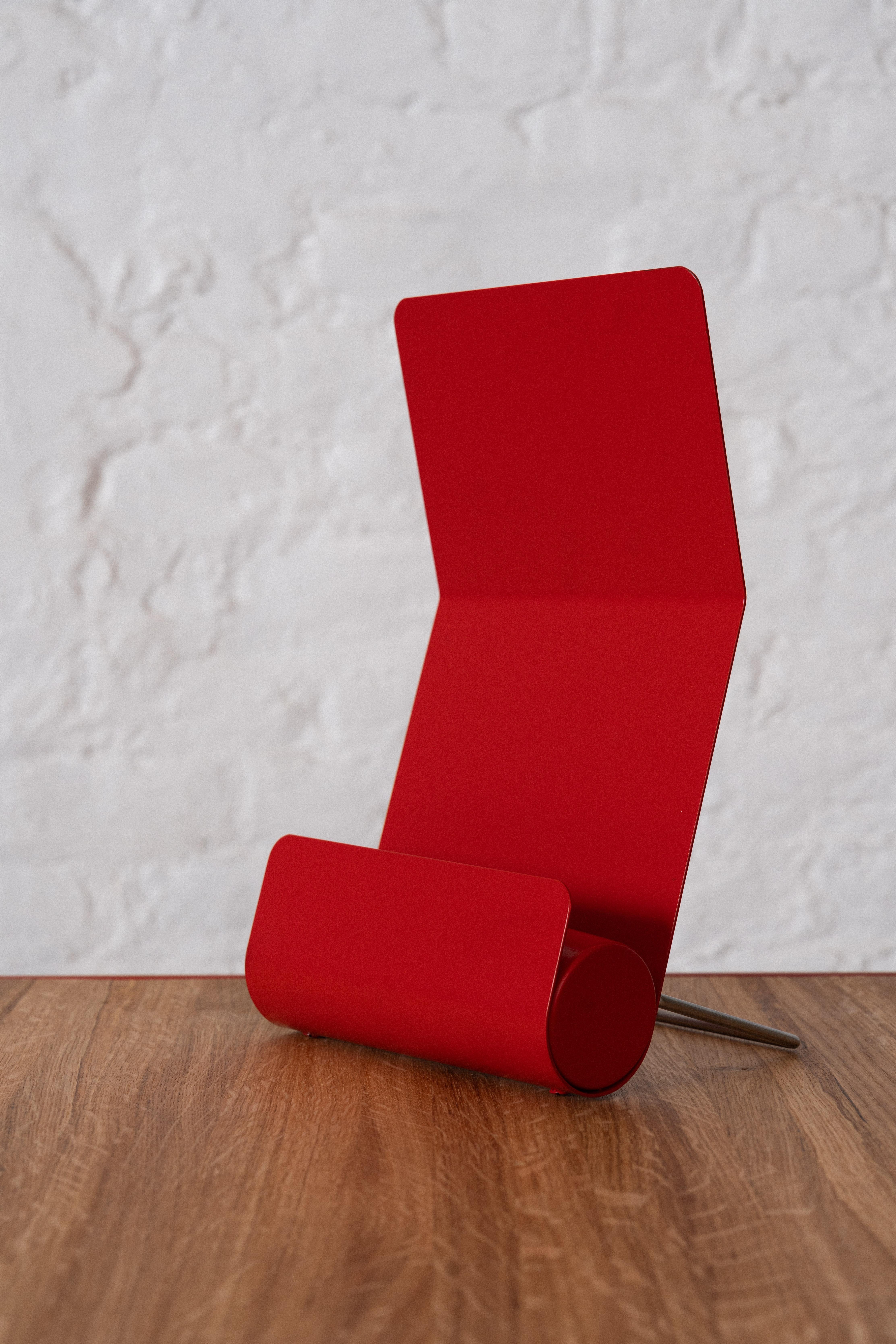 This minimal table lamp known as ‘GE 50’ was designed by the Belgian architect and designer Christophe Gevers for Light in 1975. This simple design can be used in two positions, made in red lacquered metal.