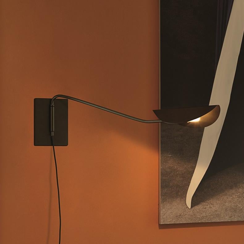 Wall lamp 'Plume' designed by Christophe Pillet in 2017.
Wall lamp giving direct light in lacquered metal. Tube-shaped structure in curved metal. Manufactured by Oluce, Italy.

Plume, designed by Christophe Pillet, a family of lamps consisting of