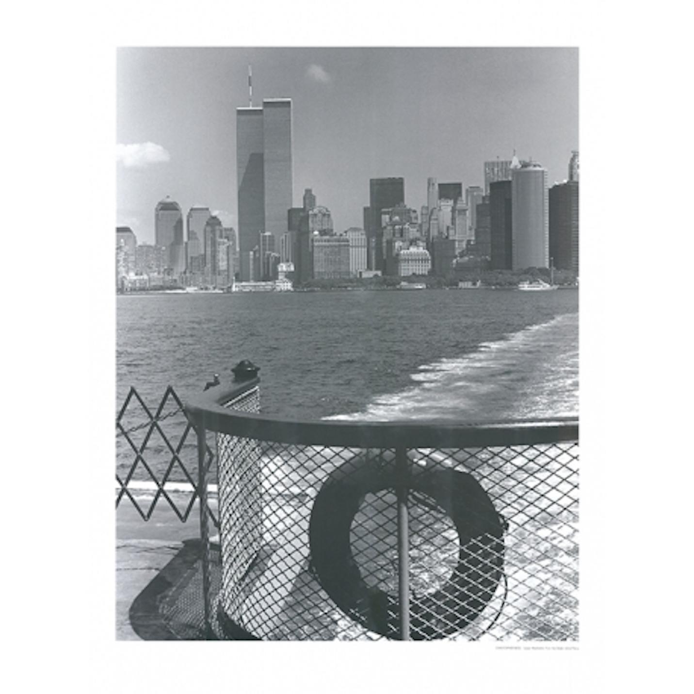 Monochrome photo with a view of the Manhattan skyline from the Staten Island Ferry board, a delightful combination of a row of skyscrapers and a water component of New York Harbor. 
Christopher Bliss is a New York based photographer who has always