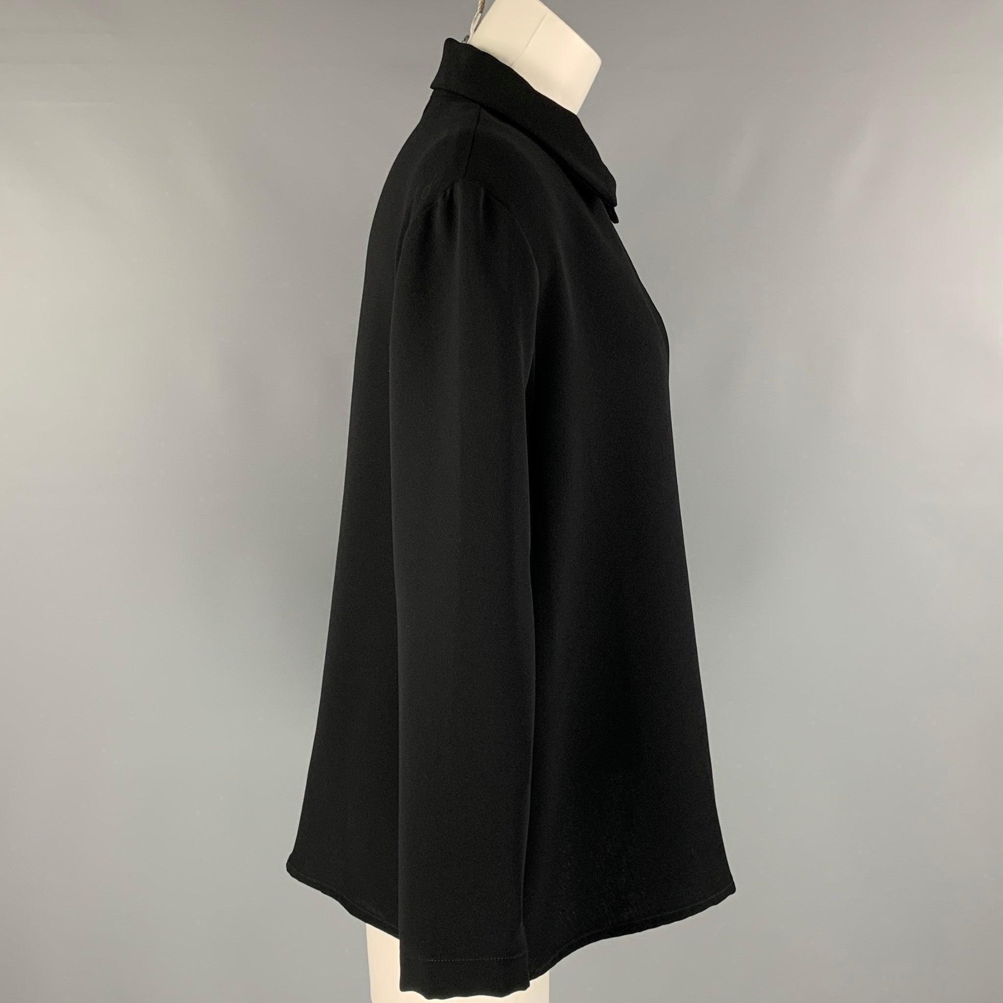 CHRISTOPHER CALVIN jacket comes in black polyester crepe fabric, straight collar, cross over button closure and unlined. Made in
 USA.
 Excellent Pre-Owned Condition.  
 

 Marked:  M 
 

 Measurements: 
  
 Shoulder: 17 inches Bust: 44 inches