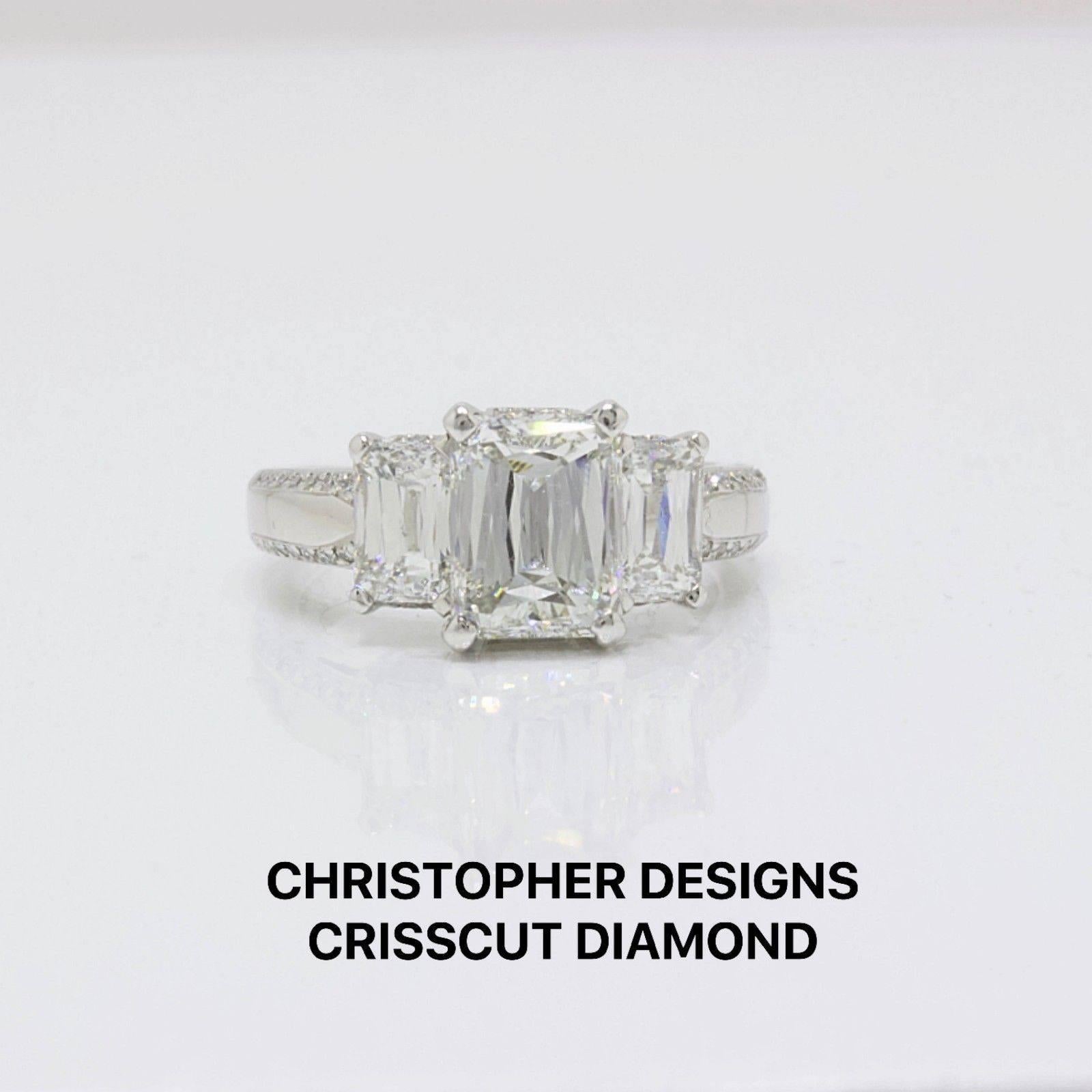 Christopher Designs 
Three Stone Crisscut Emerald Diamonds Engagement Ring.  
Main Center Diamond is 2.16 CTS. J color, VS1 clarity.... Diamond is inscribed 5223103.  
Two Side Stones are 1.53 TCW.  J color, VS1 clarity.  
Two Rows of accent