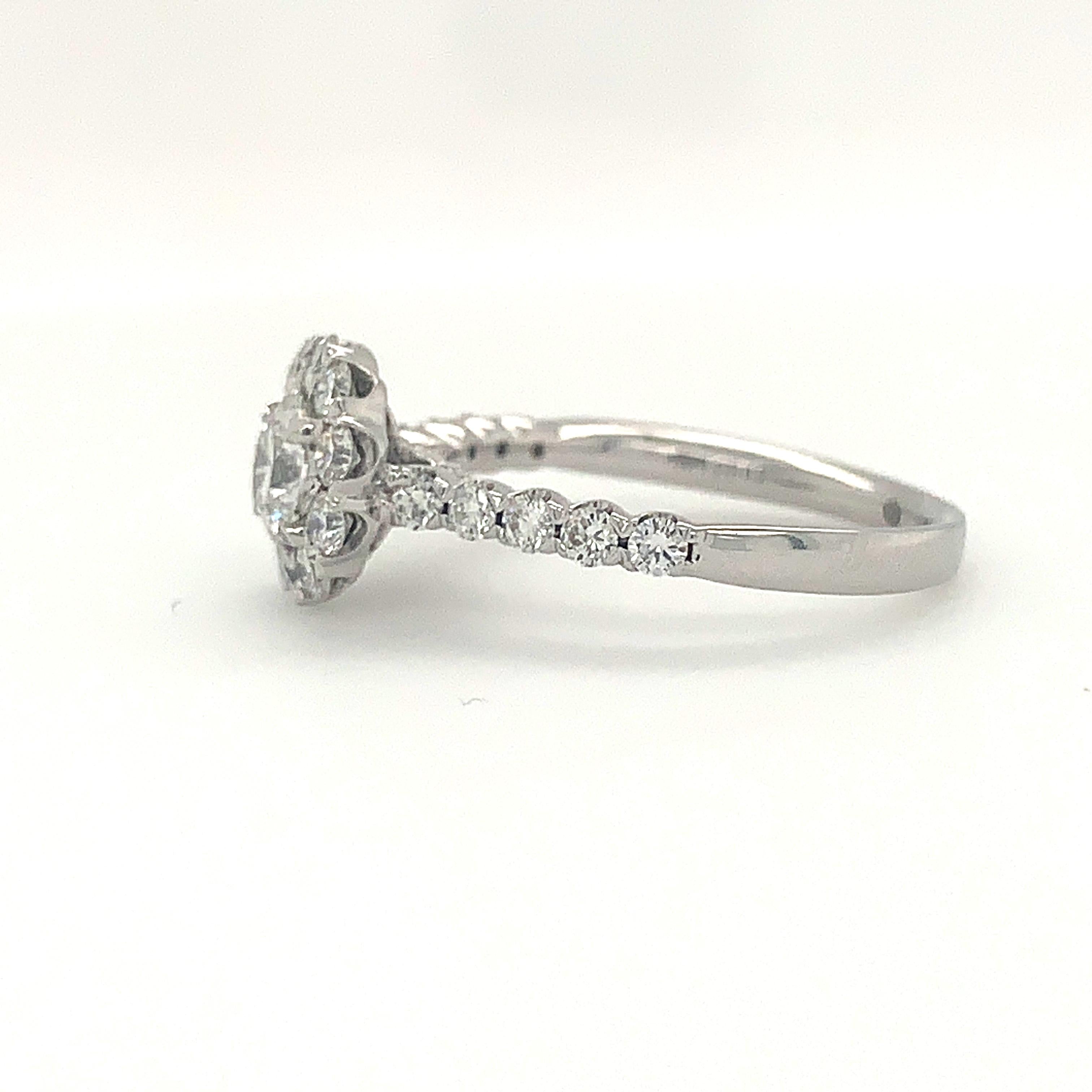 Boasting a magnificent design of 29 Round Brilliant Diamonds with a total carat weight of 0.75cts, the Christopher Designs Crisscut® Round Halo Diamond Engagement Ring in 18K White Gold also features a stunning modified brilliant Crisscut® in the