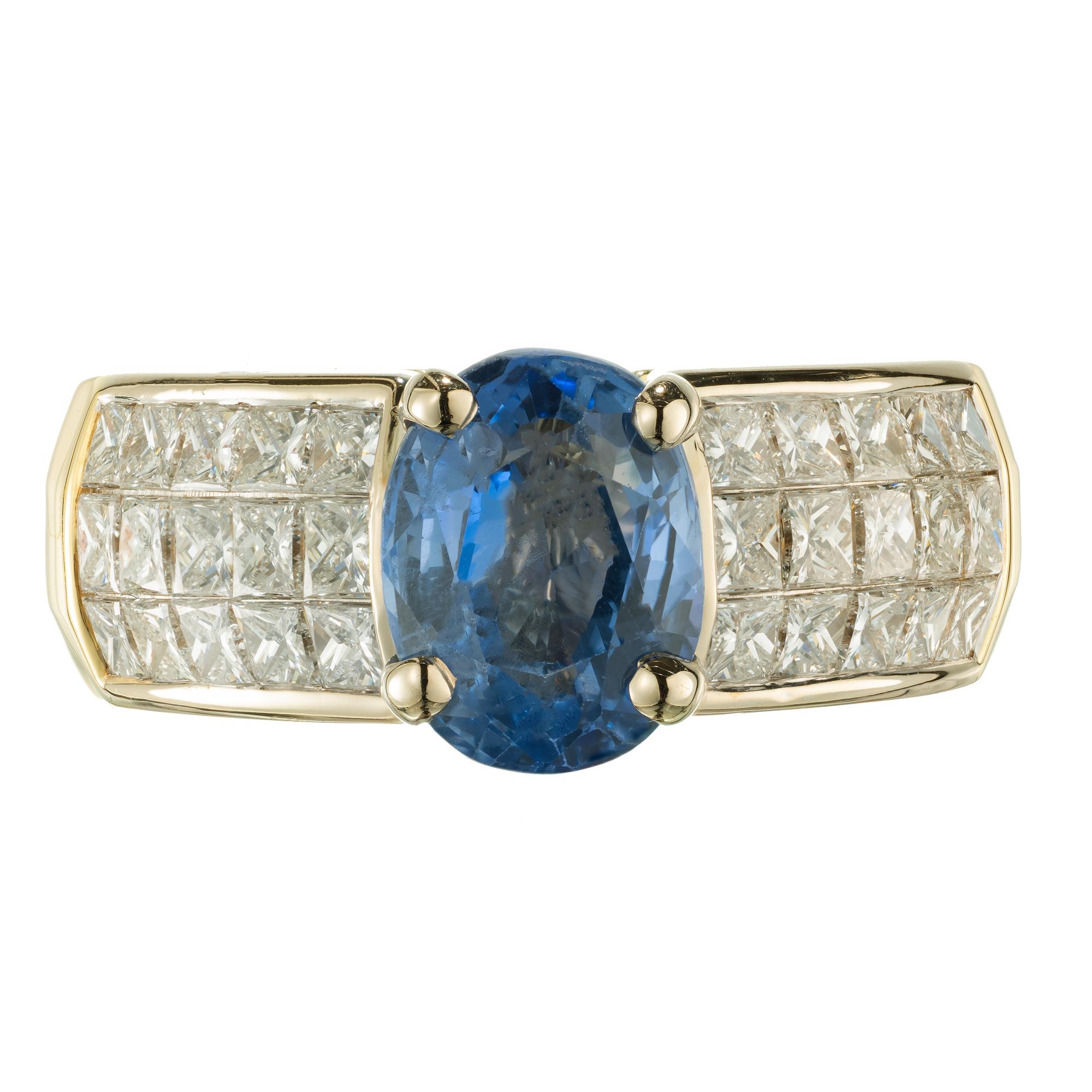 Christopher designs sapphire and diamond ring. Oval sapphire set in 18k yellow gold setting with three rows of 1.50 carats of bright princess cut diamonds. GIA certified as natural no heat

1 oval blue sapphire, approx. 2.37cts SI GIA Certificate