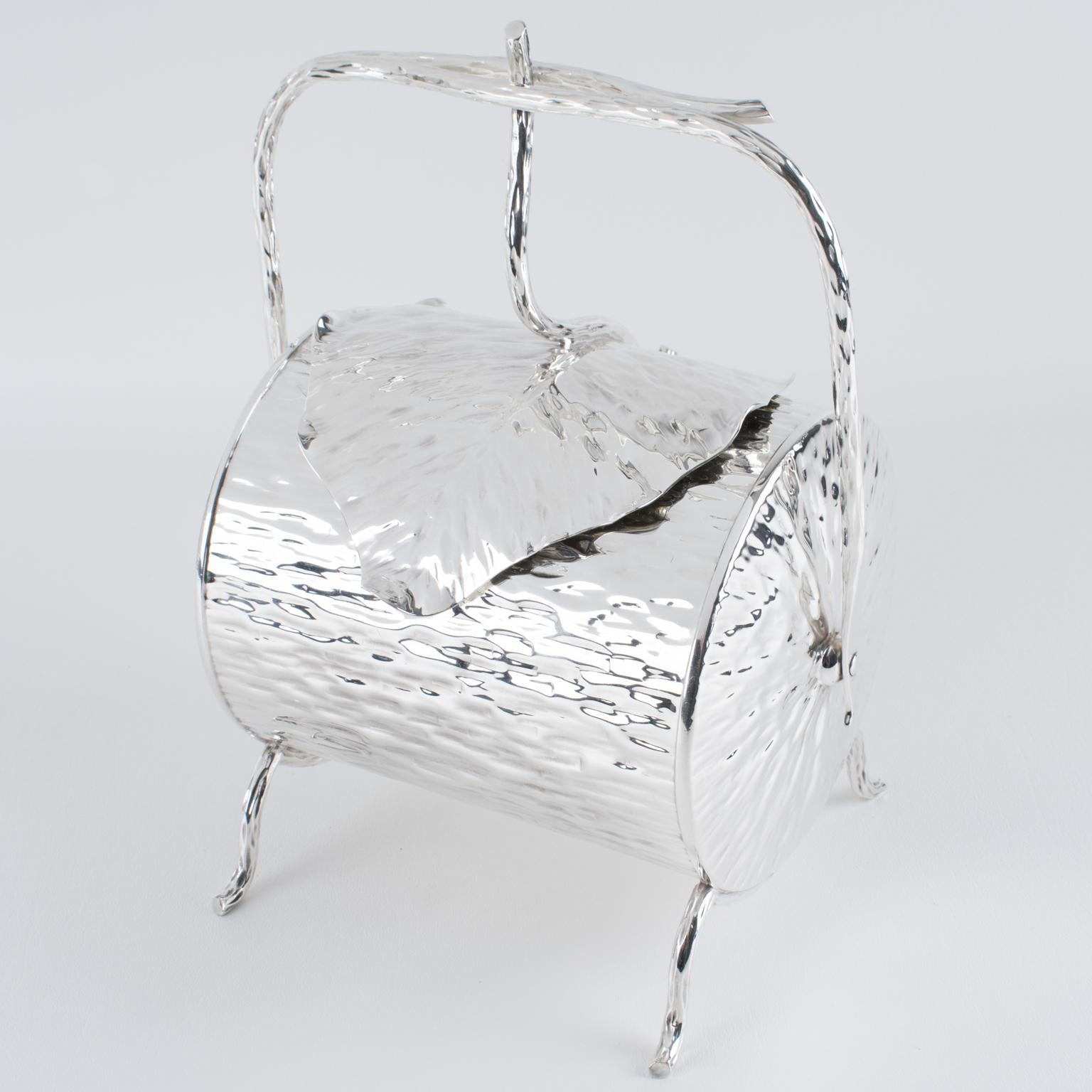 A magnificent hammered silver plate candy box designed by Dr. Christopher Dresser for Hukin & Heath, boasting an elegant scrolled branch handle and a beautifully ruffled lid. The base bears the hallmark of Hukin & Heath, showcasing its distinguished