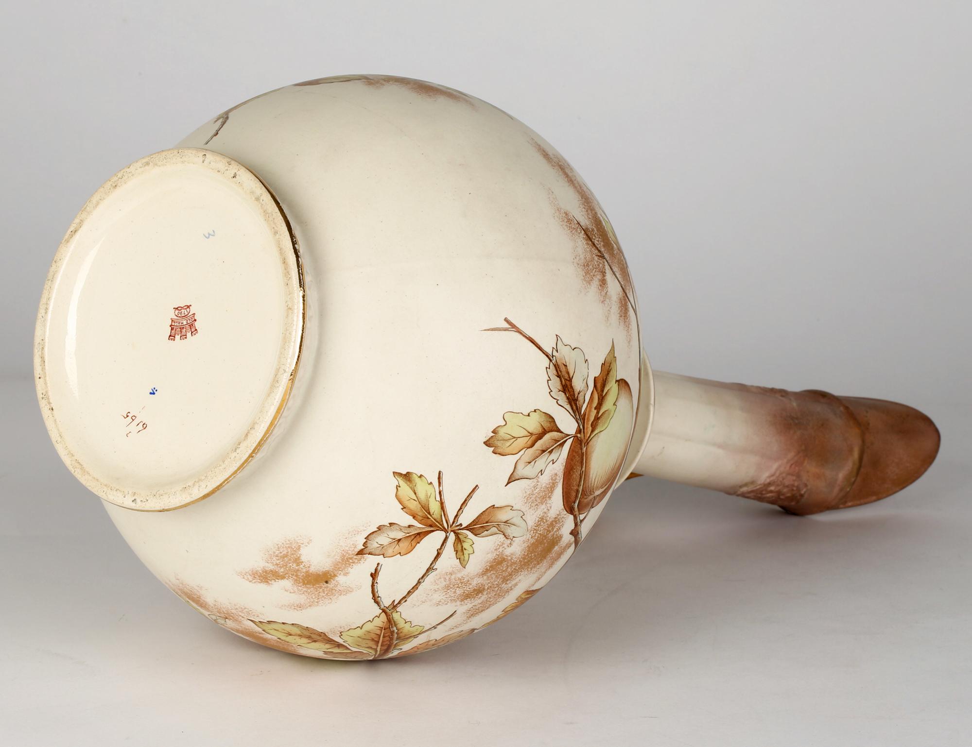 A large and rare Old Hall Aesthetic Movement ewer hand painted with a blue tit perched on a crab apple tree designed by Christopher Dresser (British, 1834-1904) and dating from around 1885. This impressive earthenware ewer is made in the Japonesque