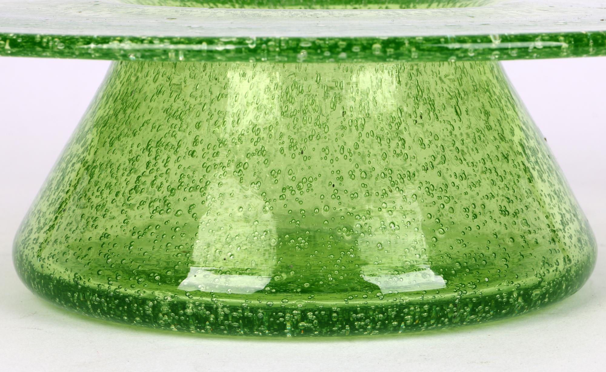 A large Arts & Crafts ‘Clutha’ art glass bowl designed by Christopher Dresser (British, 1834-1904) attributed to Thomas Webb and dated 1879. The bowl is of distinctive wide rounded shape standing on a wide round foot with short conical shaped body