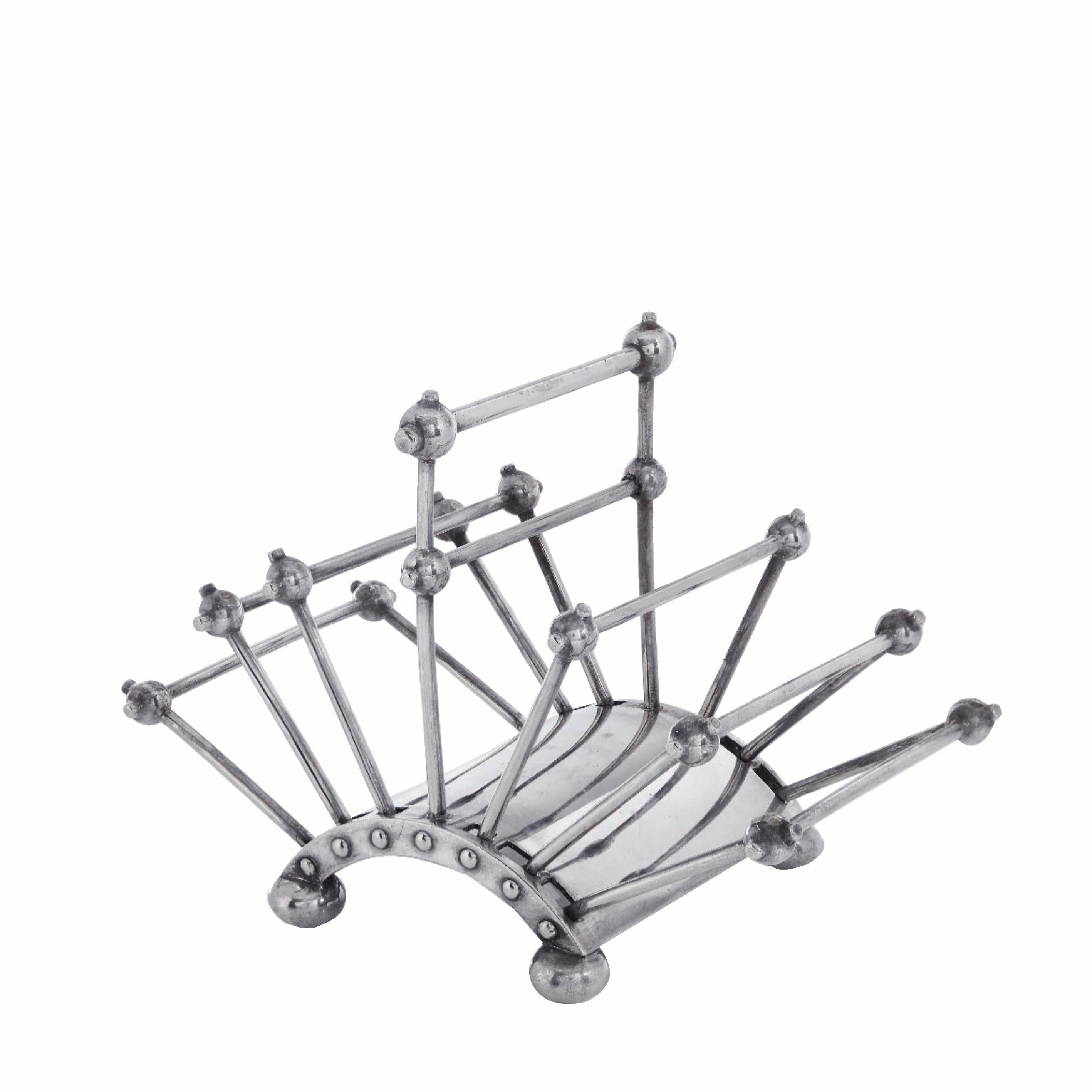 Silver-plated letter folding rack, designed by Christopher Dresser circa 1880 and manufactured by Hukin & Heath, Birmingham circa 1881, in a toast rack form with one central fixed division and six flanking moveable divisions on an arched base and