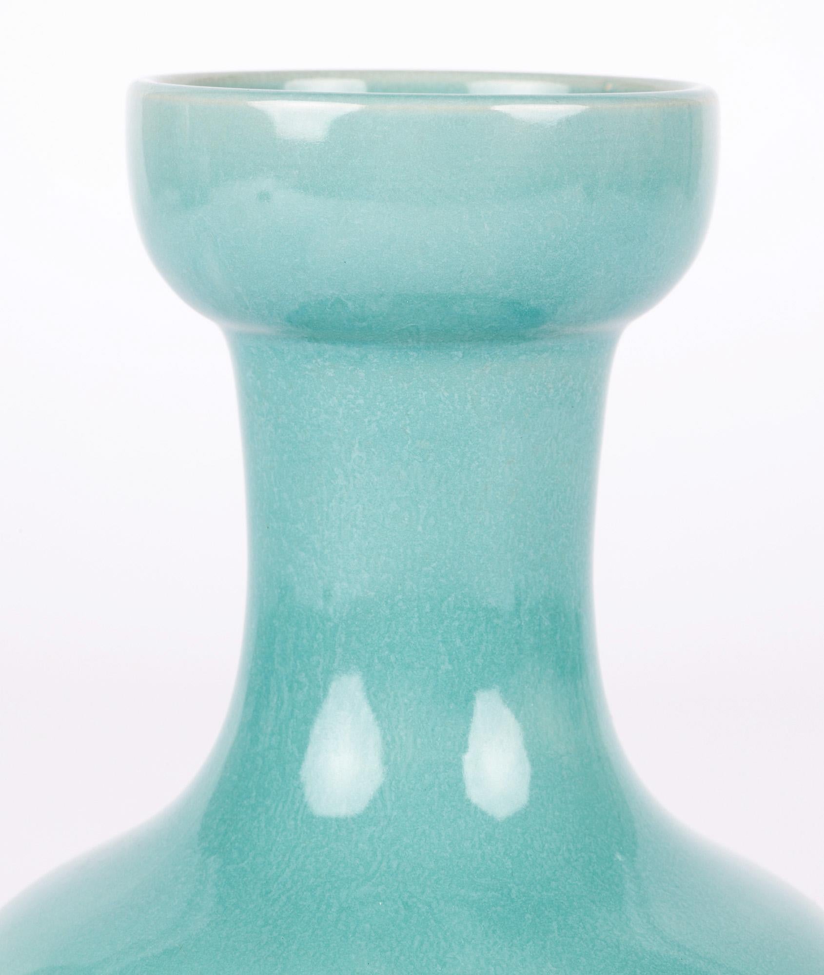 Scarce Arts & Crafts Samuel Lear turquoise majolica glazed art pottery vase designed by Christopher Dresser dating from around 1885. The vase stands on a narrow rounded unglazed foot rim with recessed base and has a wide squat round lower body,