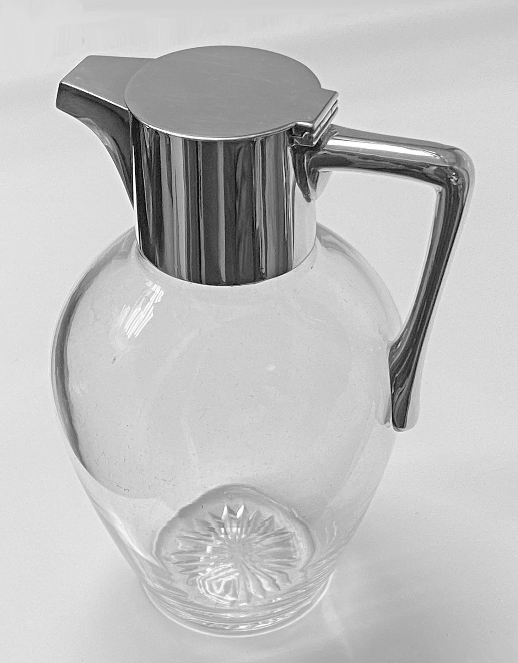 A Christopher dresser (1834-1904) attributed glass & sterling silver claret Jug, London 1897 Heath and Middleton. Plain form, star cut base. Height 19 cm. Similar example see catalogue no. M-038C Ref: 'Christopher Dresser, People's Designer'