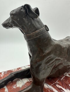 A large late 19th century French animalier bronze of a recumbent greyhound dog