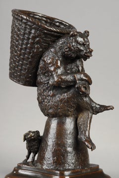 Bear carrying a basket, with a dog