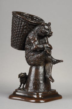 Bear carrying a basket, with a dog