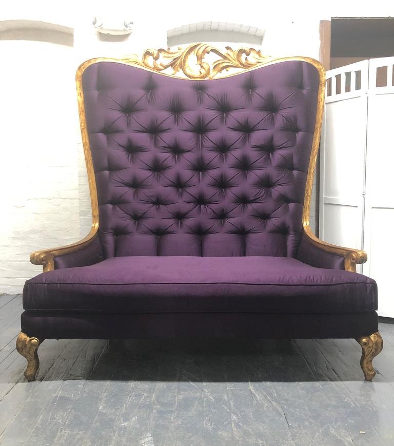 Christopher Guy tufted loveseat. It has a gold giltwood frame, a purple tufted back with four additional pillows. The seat cushion and pillows are down-filled.