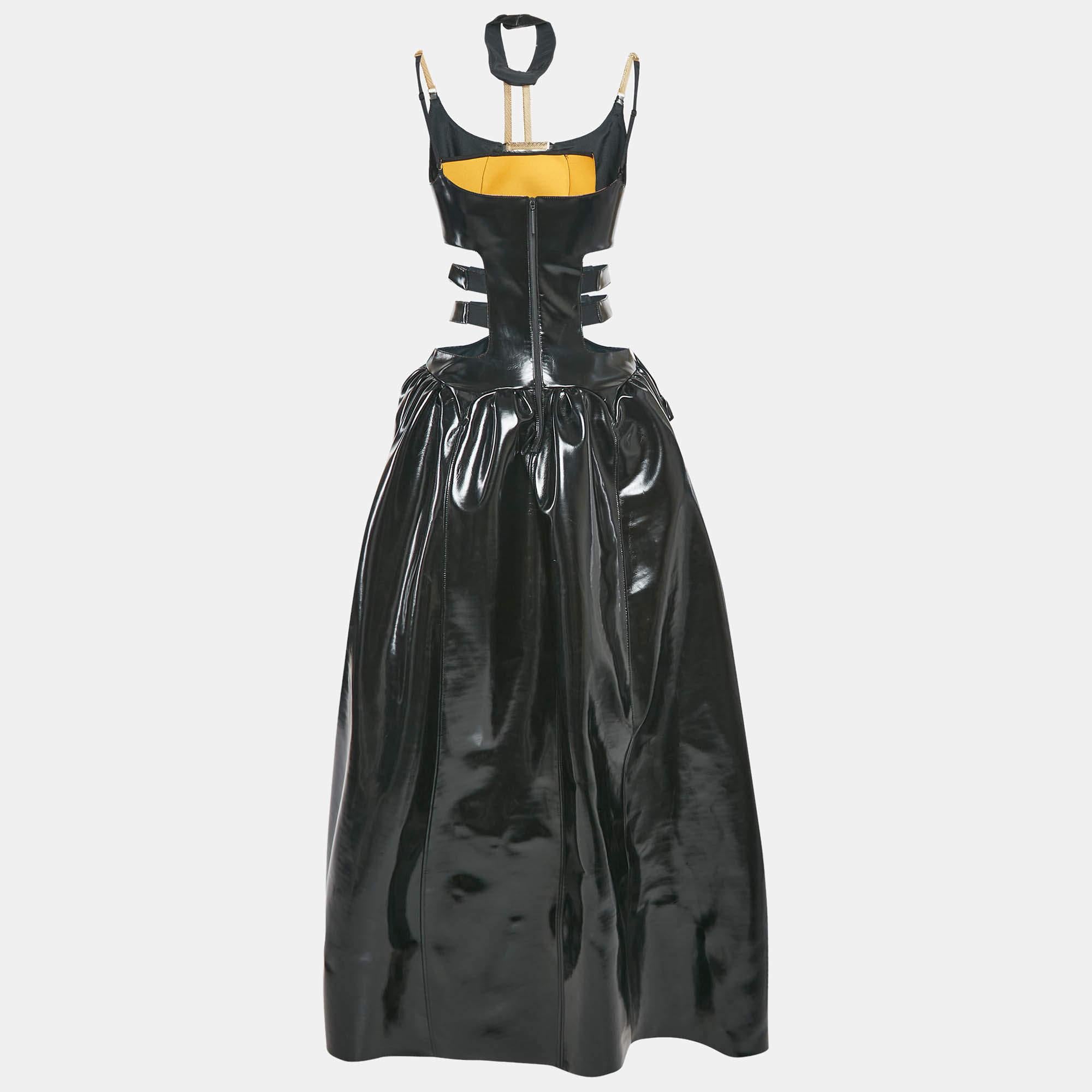 This Christopher Kane maxi dress in black faux leather showcases a bold cut out design with intricate strap detailing  blending edgy aesthetics with refined elegance. Its sleek silhouette enhances the figure  making it a statement piece for any