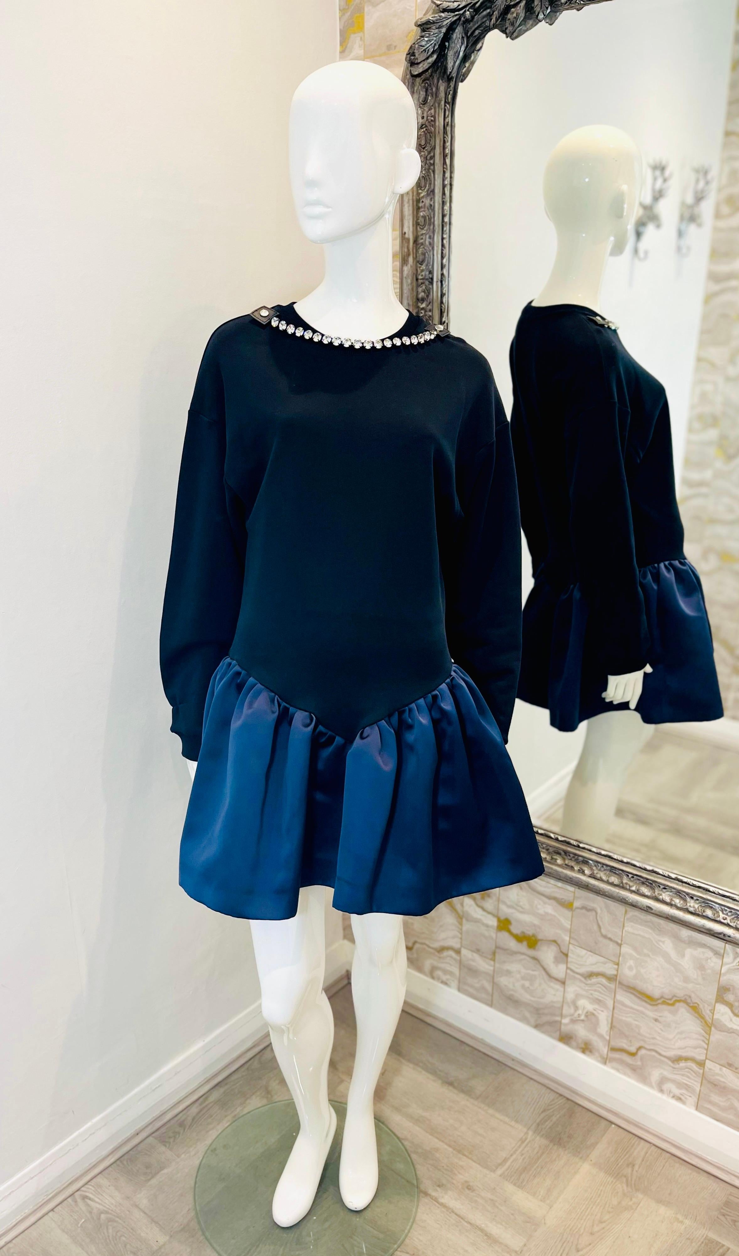 Christopher Kane Cotton Sweatshirt Dress

Mini dress designed with sweatshirt top and navy, gathered A-Line skirt.

Detailed with detachable crystal necklace detail to the crew neckline.

Featuring loose fit, long sleeves and ribbed neck and cuffs.
